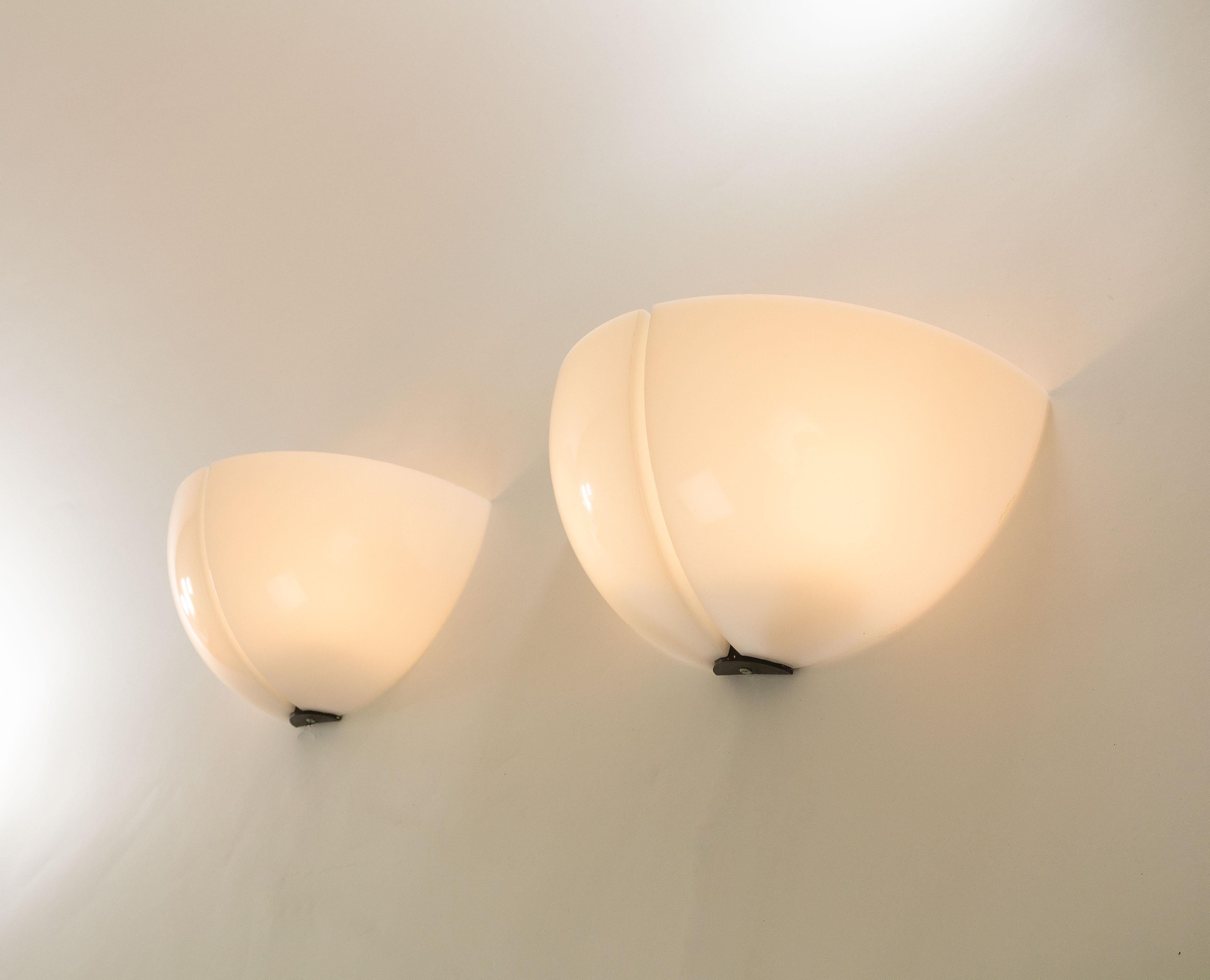 A pair of Spicchio wall lamps designed by Danilo and Corrado Aroldi and manufactured by Stilnovo in 1972.

Danilo and Corrado Aroldi designed a whole range of Spicchio lamps for Stilnovo. In our archive we found 3 different wall lamps, 2 pendants,