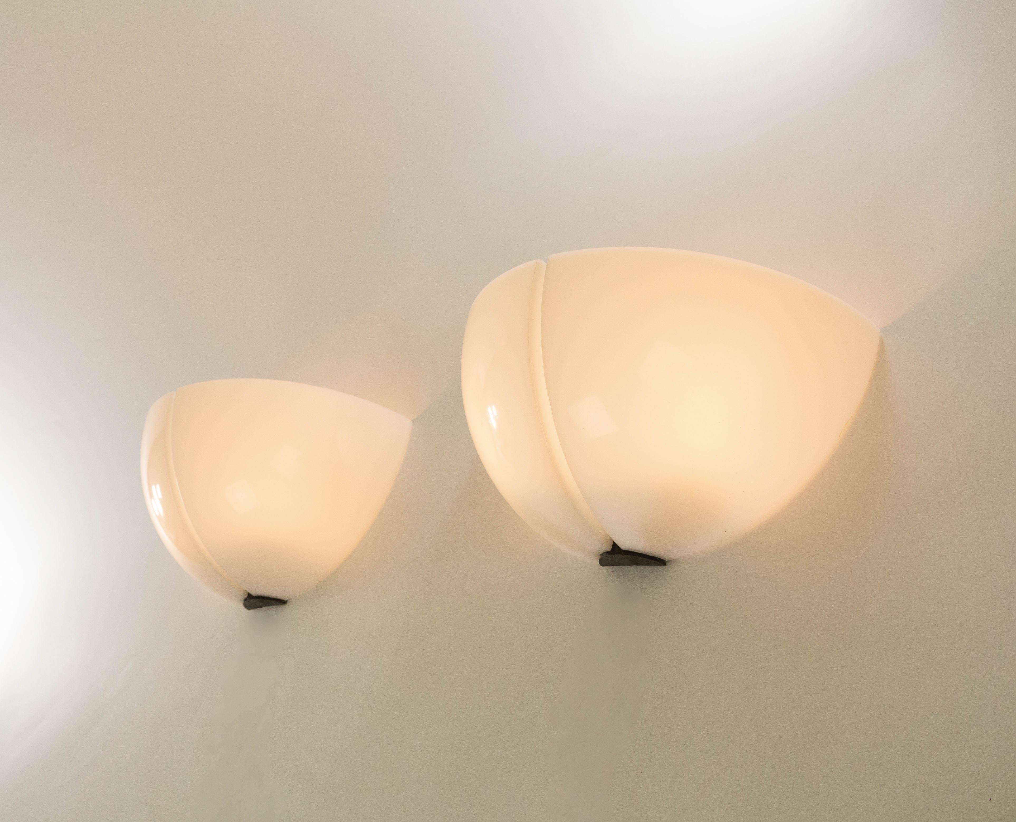 A pair of Spicchio wall lamps designed by Danilo and Corrado Aroldi and manufactured by Stilnovo in 1972.

Danilo and Corrado Aroldi designed a whole range of Spicchio lamps for Stilnovo. In our archive we found 3 different wall lamps, 2 pendants, a