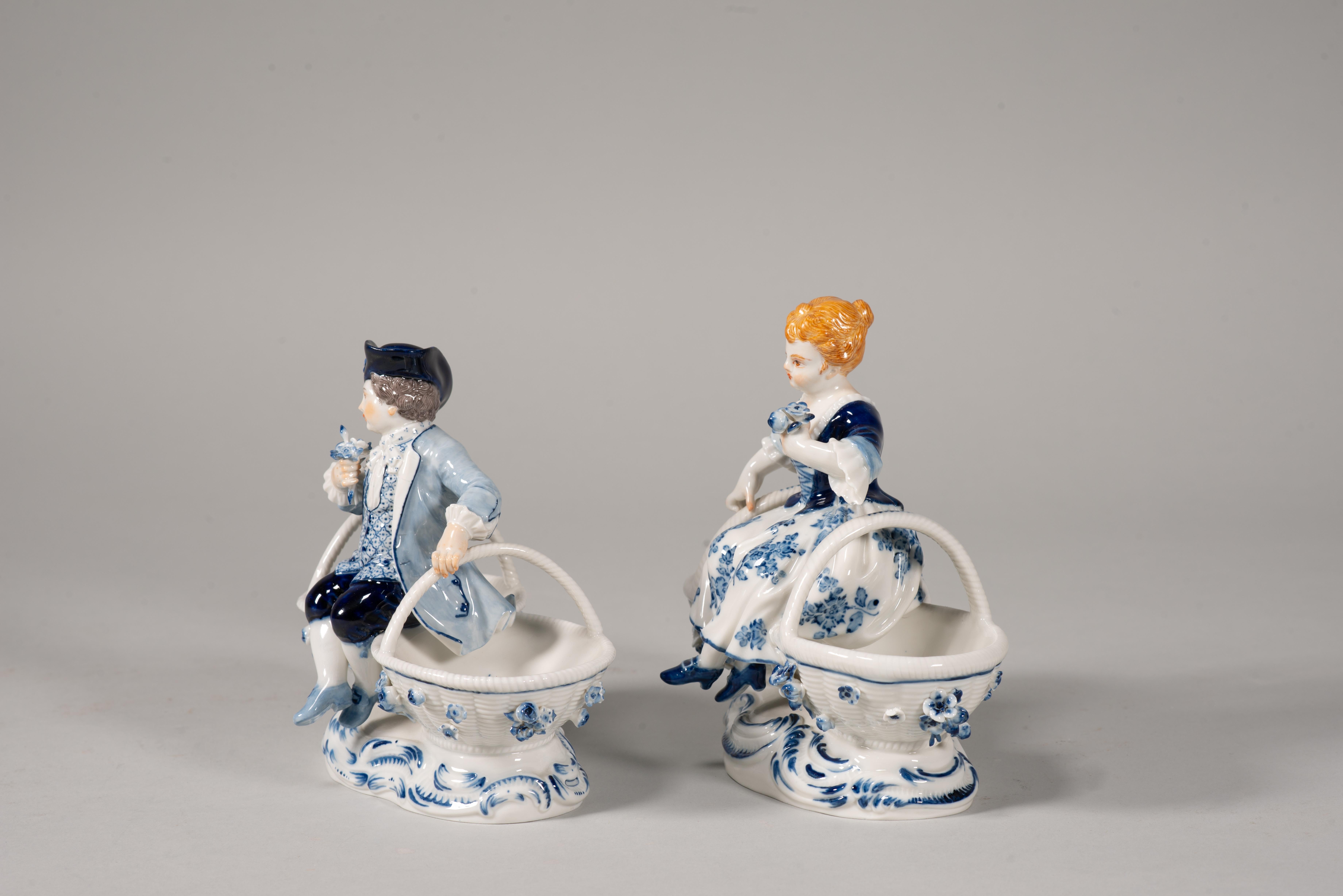 Pair of spice racks. Enameled porcelain. Meissen, Germany, possibly second half of the 19th century. 
 Marks and inscriptions on bases. 
A pair of glazed porcelain spice racks, each with a base with raised waves reminiscent of the Rococo period,