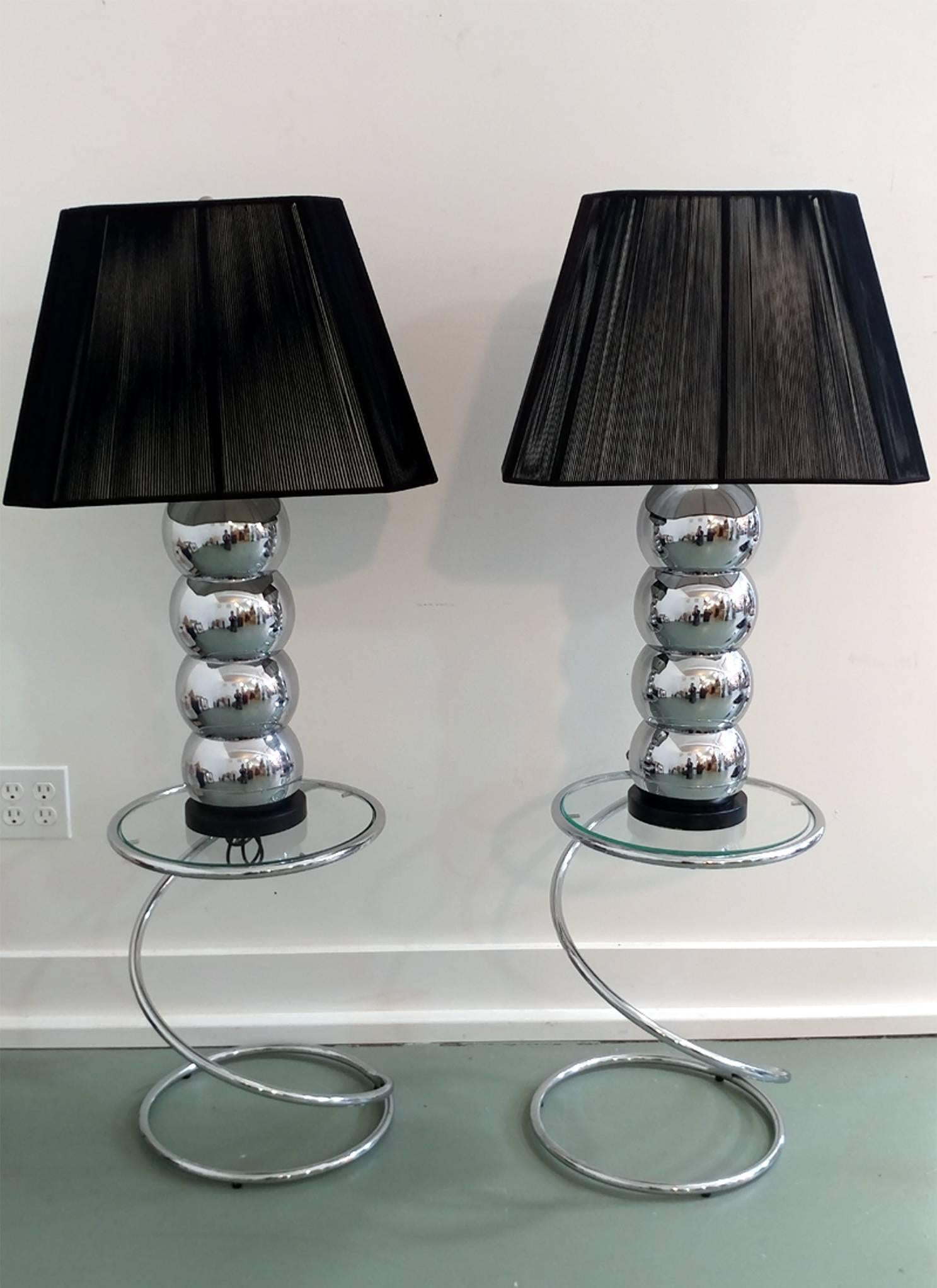 A pair of versatile occasional or bedside tables in modern spiral form designed by Leon Rosen for Pace. Polished chrome frame and glass in good original condition appropriate to age and use.