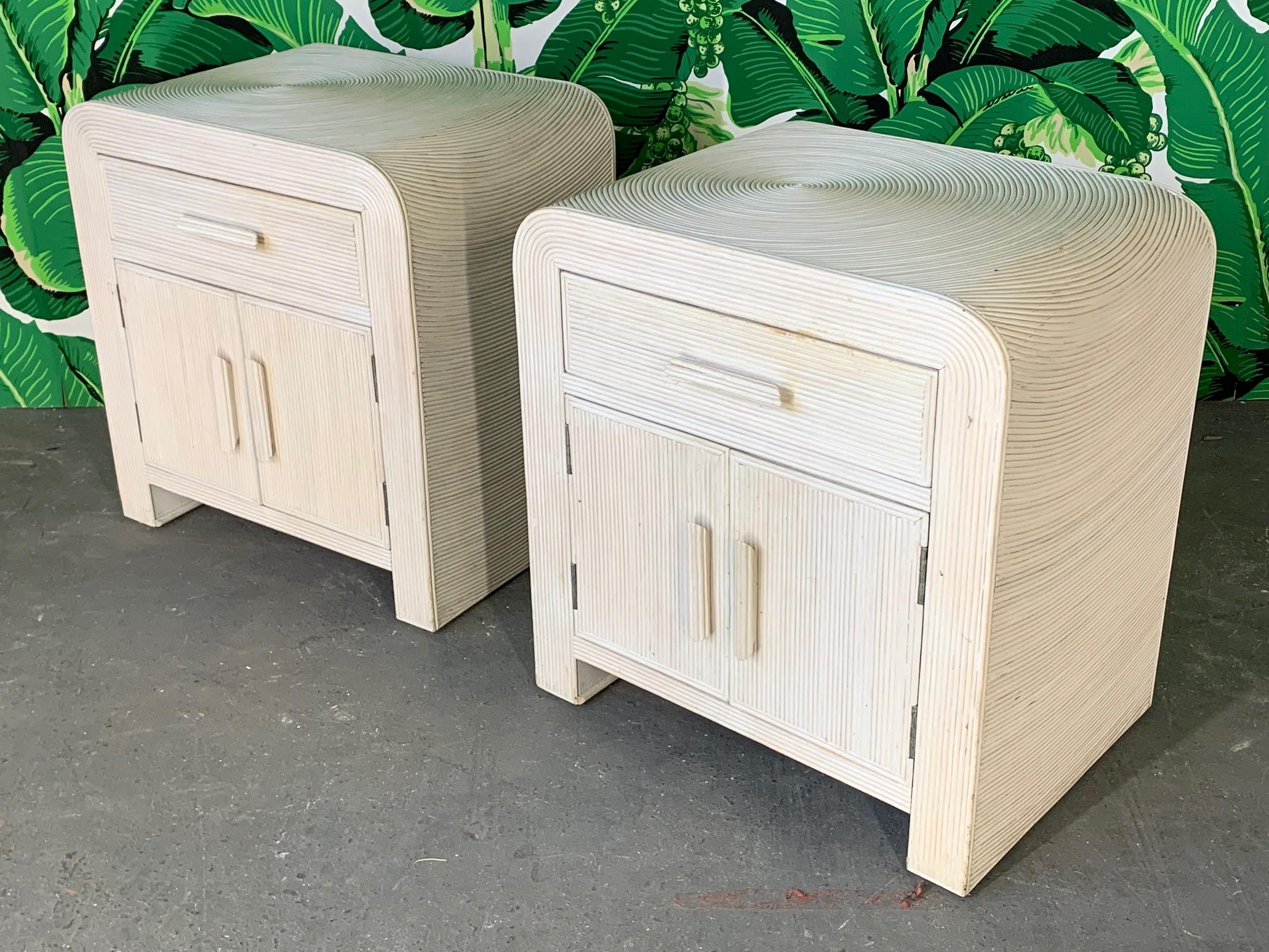 Pair of rattan nightstands wrapped in pencil reed in an artistic design in the manner of Gabriella Crespi. Very solid construction with minor imperfections consistent with age.