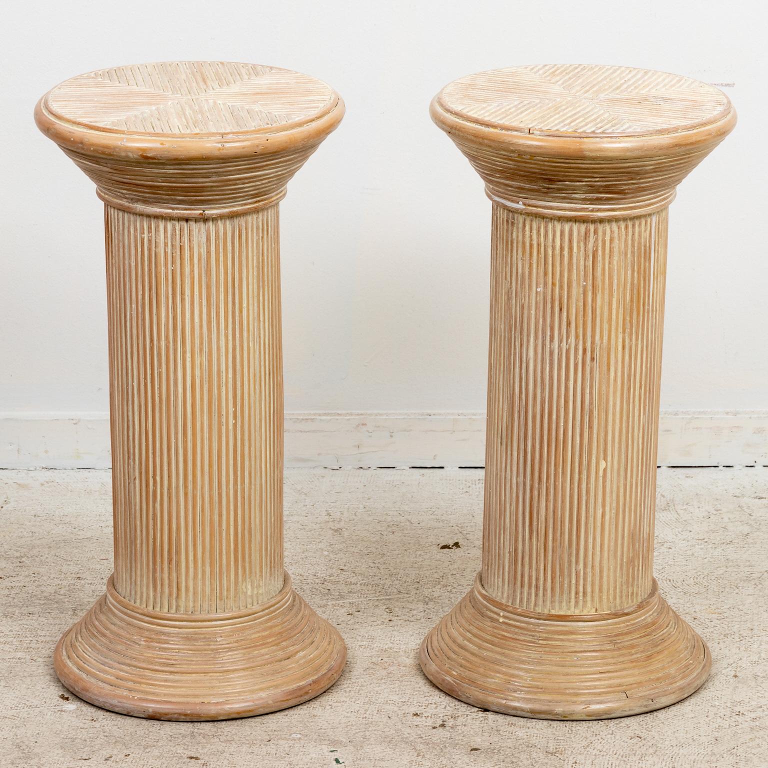 Circa mid-20th century Hollywood Regency style split reed rattan rounded pedestals or side tables. Please note of wear consistent with age and use. Good vintage condition.