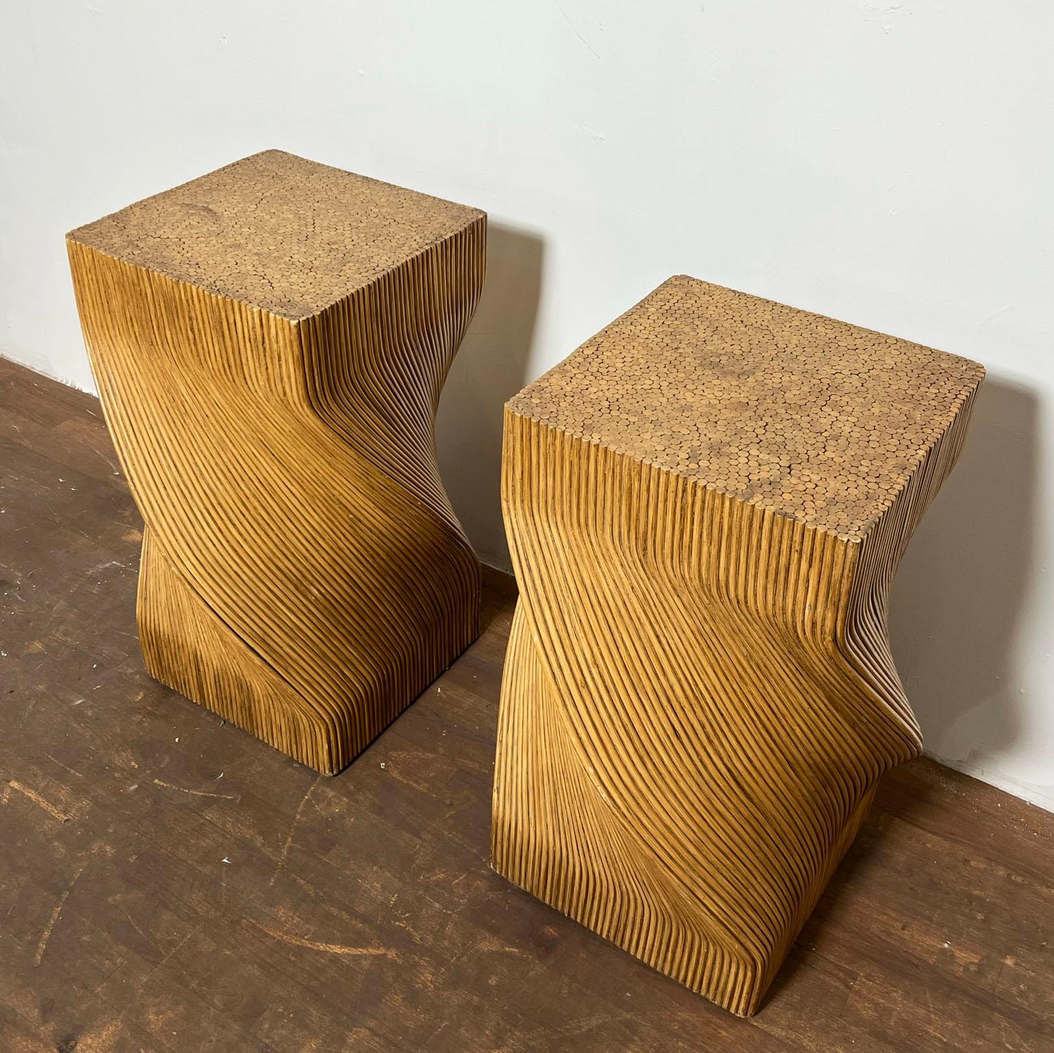 A pair of sculptural split reed lamp tables ca. 1970s. Can also serve as pedestals, either for sculpture, or together as a base for a glass top dining table. Both retain labels indicating these were handmade in the Philippines. Measure 20