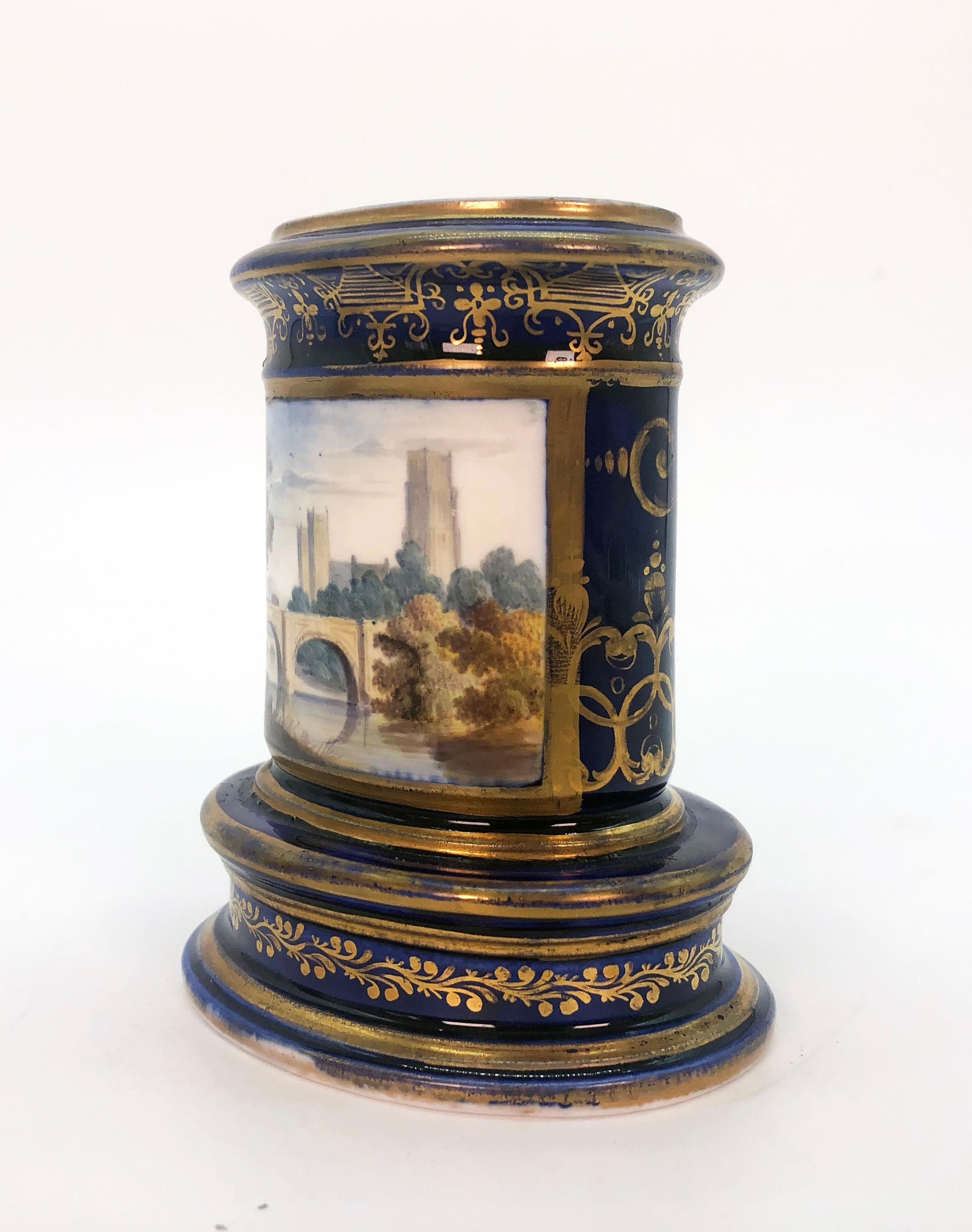 Pair of Spode spill vases, circa 1820. Cobalt blue and gilt with finely painted scenic panels, both depicting Cathedral City views. Marked to bases 'Durham/Spode' and 'The Cathedral and port of the city of Hereford/Spode' respectively. A spill vase