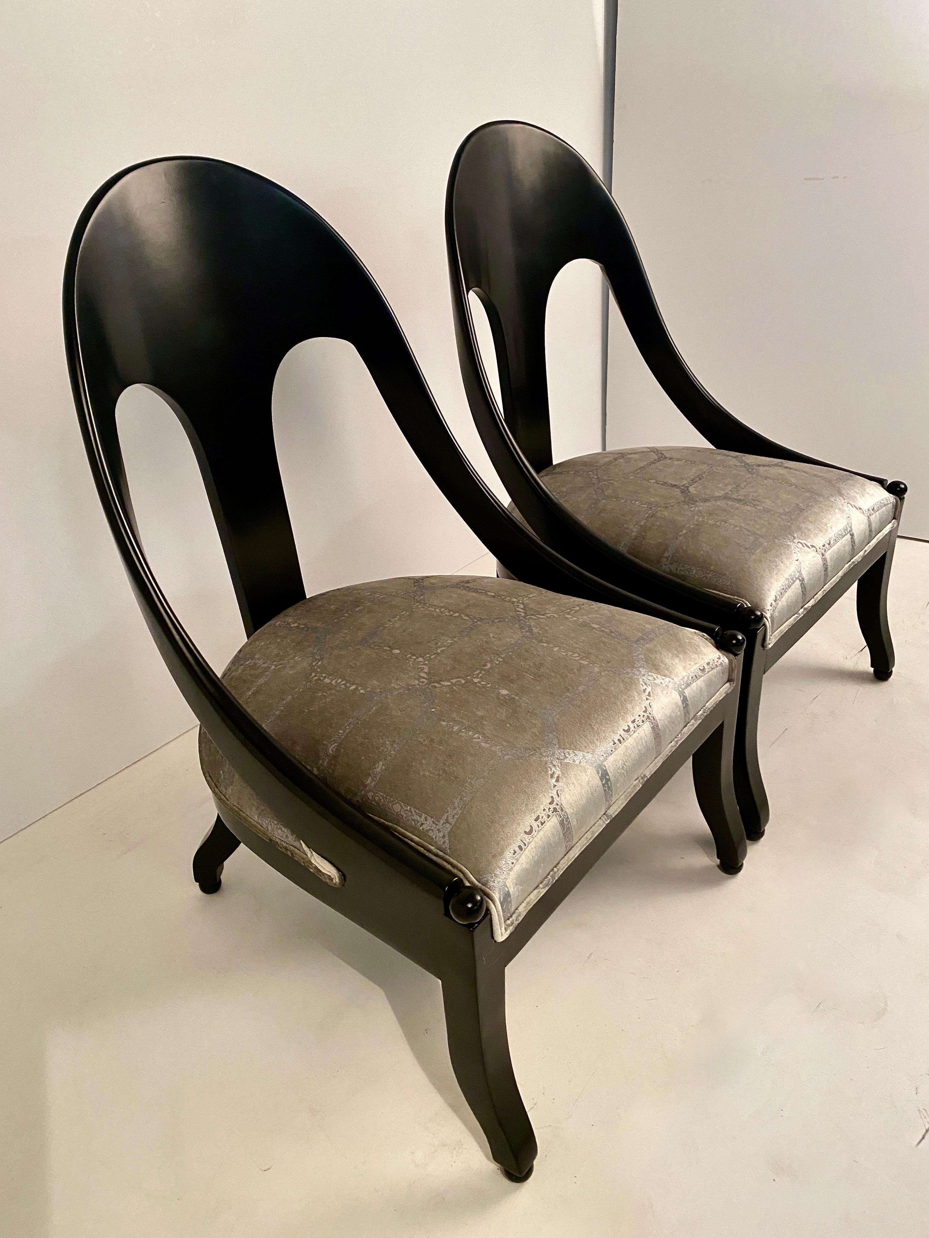 A classic pair of spoon back slipper chairs newly lacquered in black satin lacquer and newly upholstered in silvery silk velvet. An iconic form with great style and sophistication.