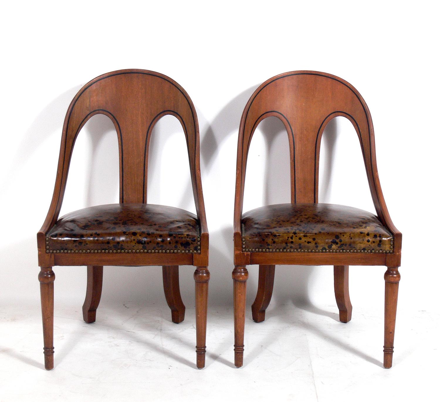 Pair of spoonback chairs with oil spot leather seats, American, circa 1960s.