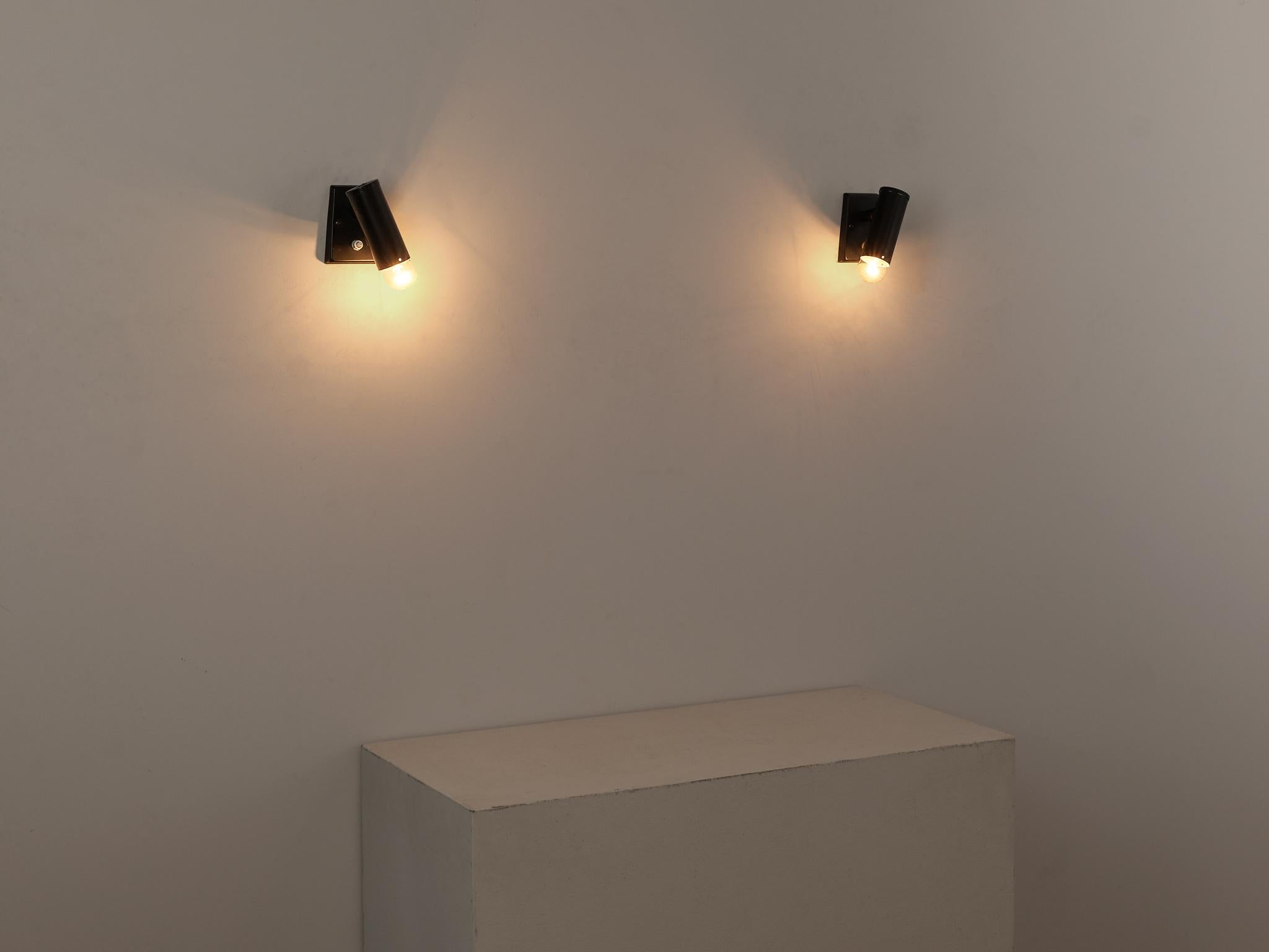 Pair of wall lights, coated metal and aluminum, Europe, 1960s

Pair of sleek and modern spot light fixtures that can be attached to the wall to enlighten a space or room. The rotatable cylindrical-shaped shade allows the user to direct the light