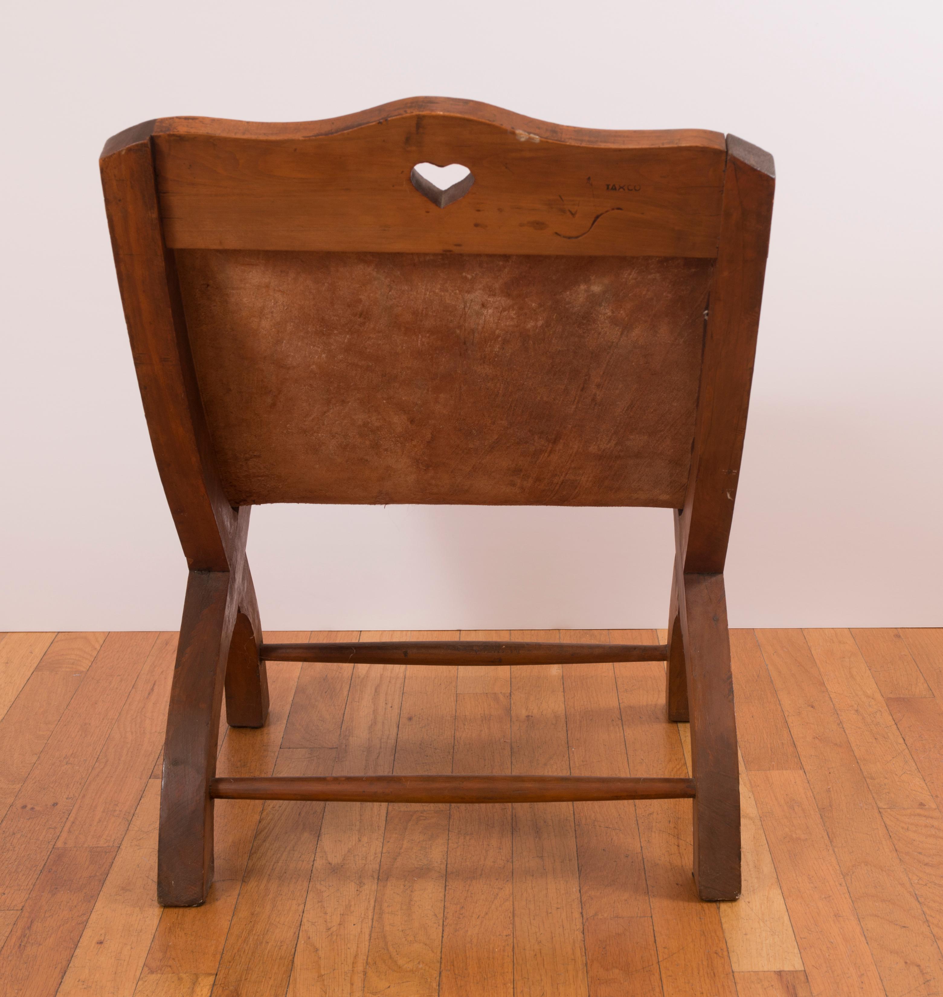 Sabino wood and tanned leather scoop seat secured by hand-hammered tacks.