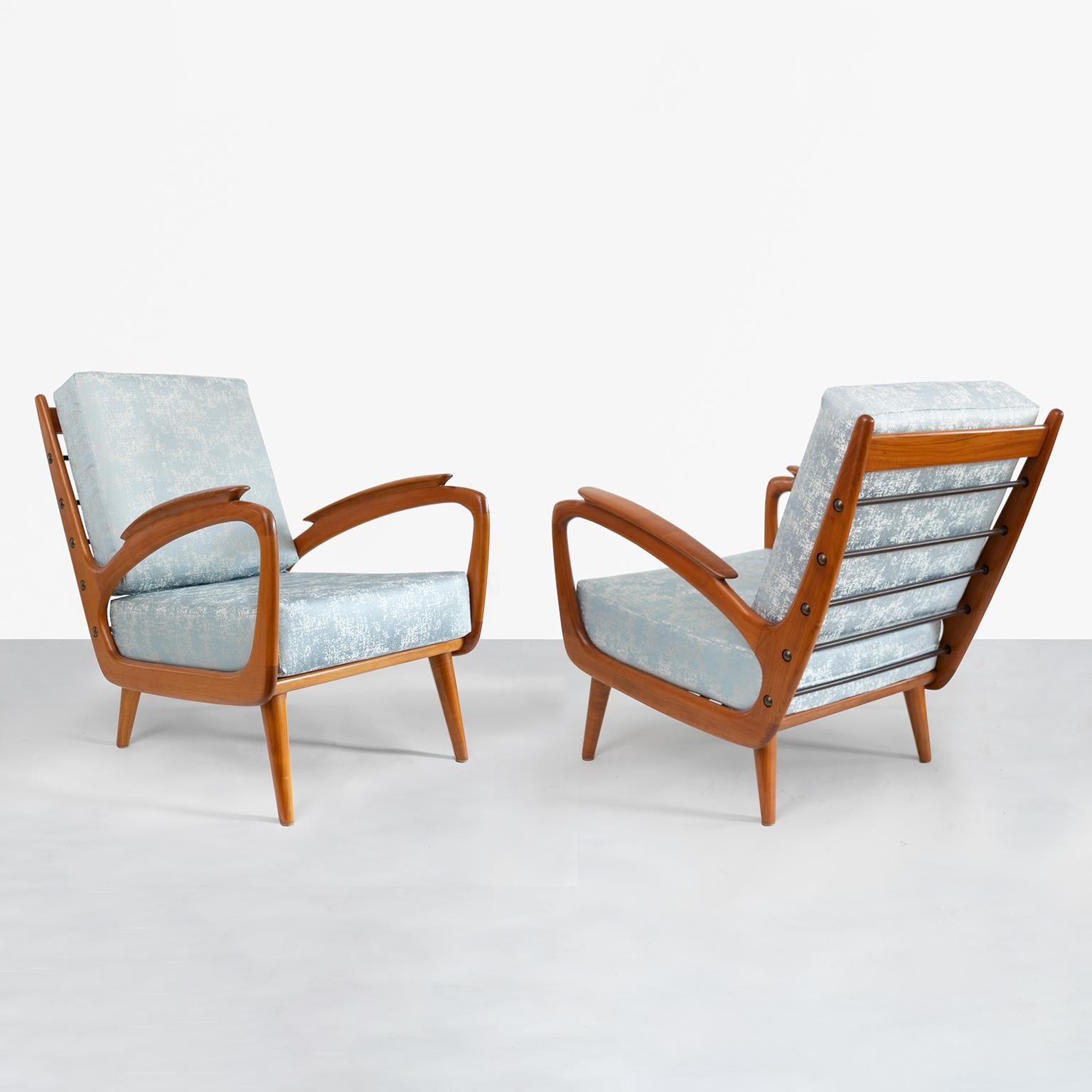 Sleek and dynamic pair of carved cherrywood Mid-Century Modern armchairs from B. Sprij Vlaardingen, Netherlands. The chair’s design plays with negative space and are reminiscent of the works of sculptor Henry Moore. A series of vinyl wrapped coil