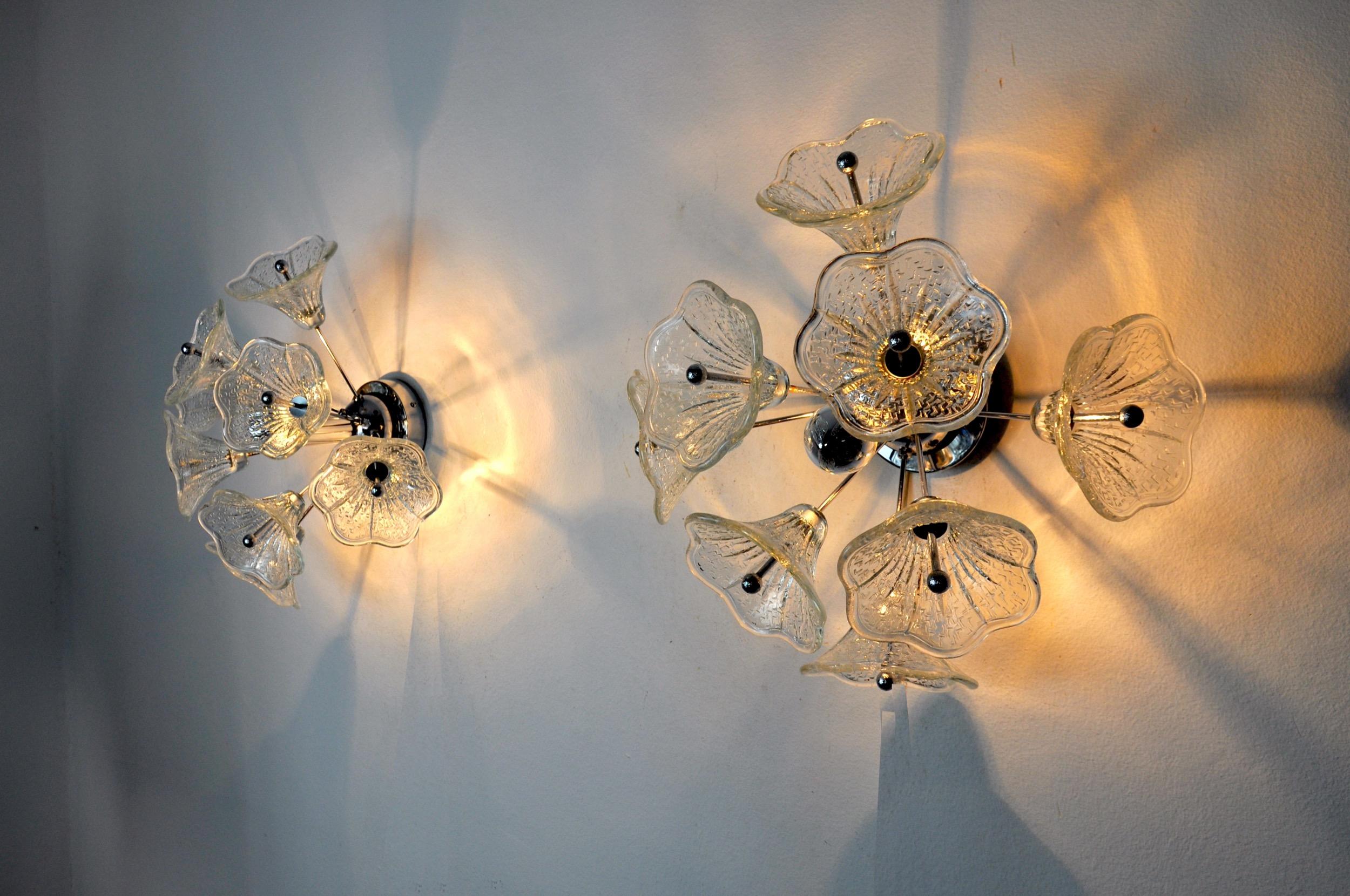 Superb and rare pair of sputnik sconces designed and produced by murano mazzega in italy in the 1970s.

These two sconces are composed of 8 arms each supporting a flower made of murano glass.

Rare design object that will illuminate your