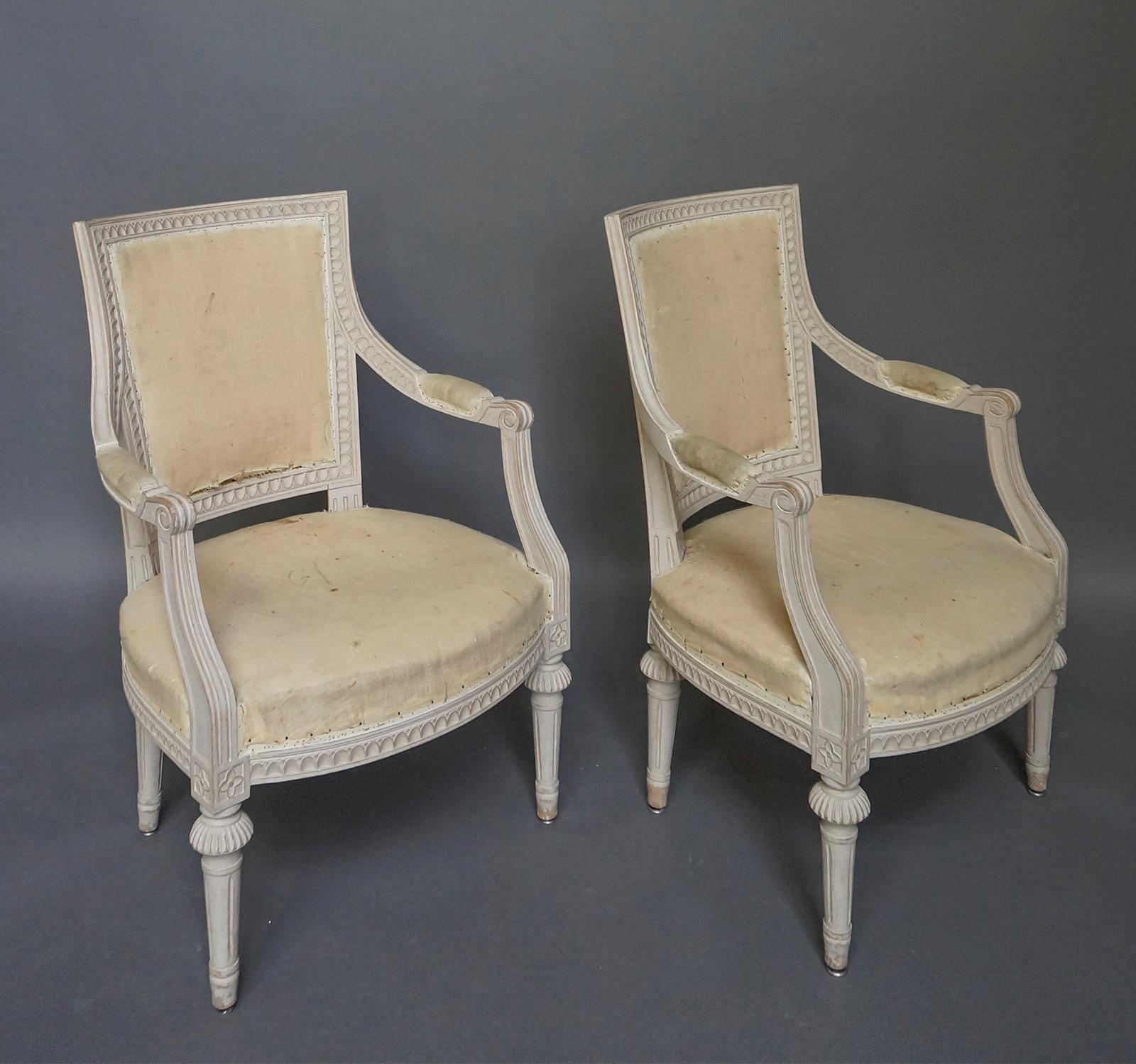Pair of armchairs, Sweden, circa 1910, in the Gustavian style. The upholstered backs and seats are surrounded with lambs tongue molding which extends on to the curving armrests. Round, tapering legs. Sturdy and quite comfortable.
