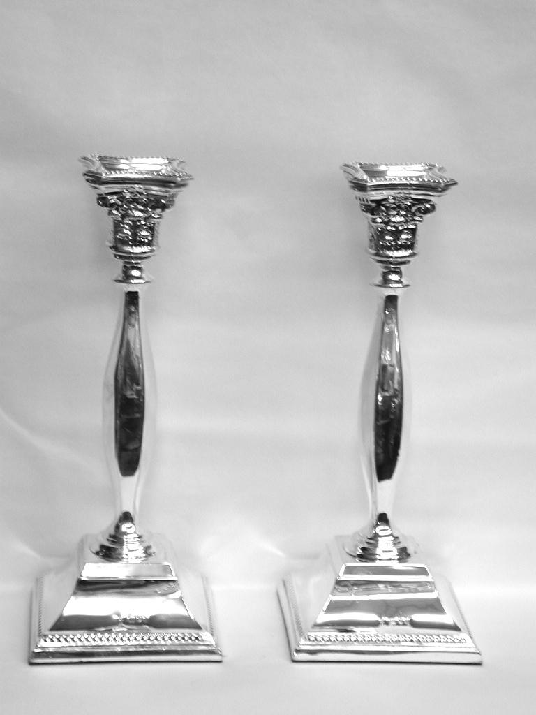 Pair of square base silver candlesticks dated 1965, London, made by David Shure.
Heavy gauge of silver, made by a prominent candlestick maker of the 1960s.
Nicely beaded with embossed silver capitals.