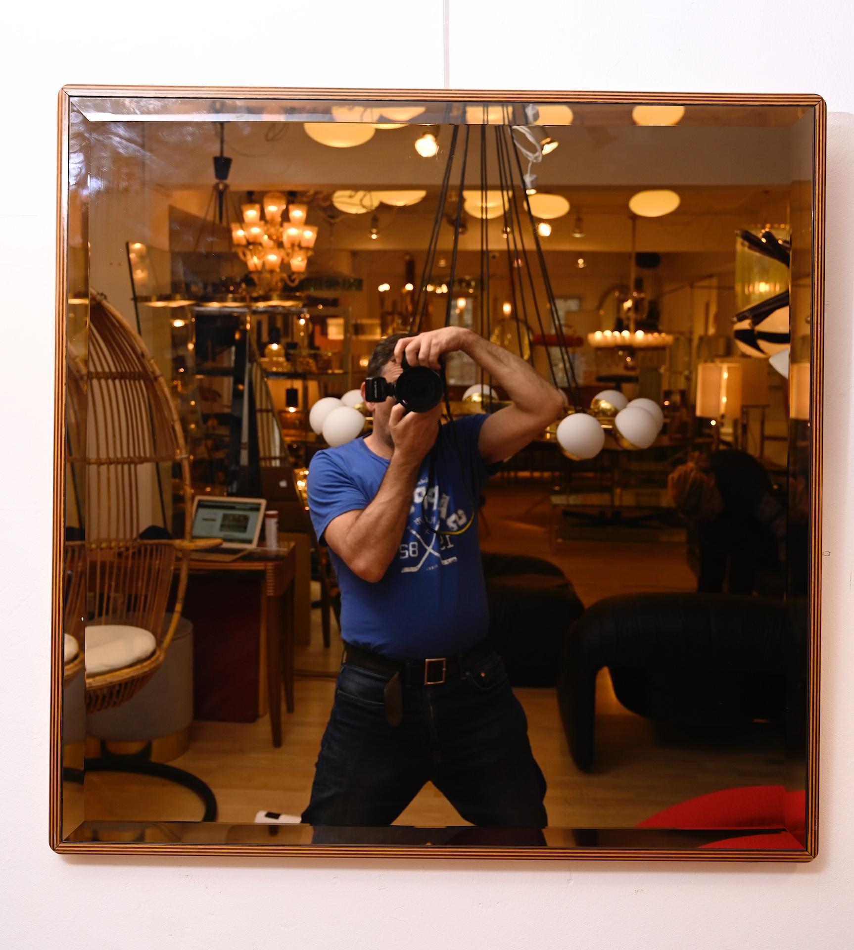 A pair of Italian 1970s bronzed mirrors with bi color Sottsass style wood frame.

In excellent condition. 
 