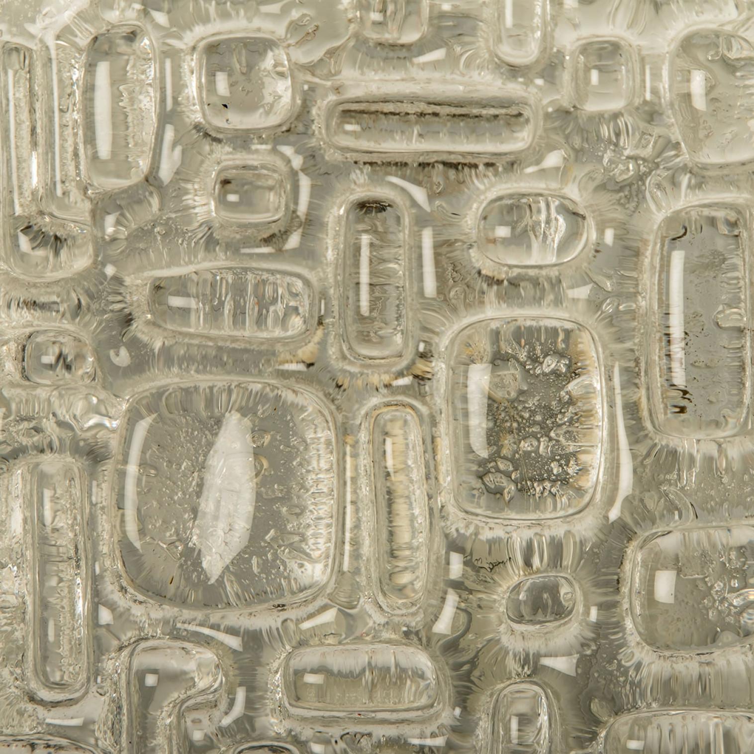 Square bubble glass wall , Germany 1960. The bubble glass creates a beautiful illumination. The glass is mounted on a with metal back plate with brass screws.

Please notice the price is for the pair.

Cleaned, well-wired and ready to use. This