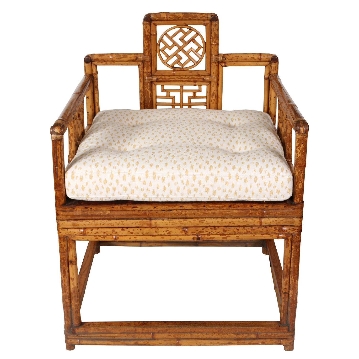 A pair of square shaped Chinese bamboo chairs with newly upholstered tufted cushions.  Add a bit of exotic flair to your space with bamboo chairs that feature a square shape to lend a contemporary edge to its traditional design. A defining feature