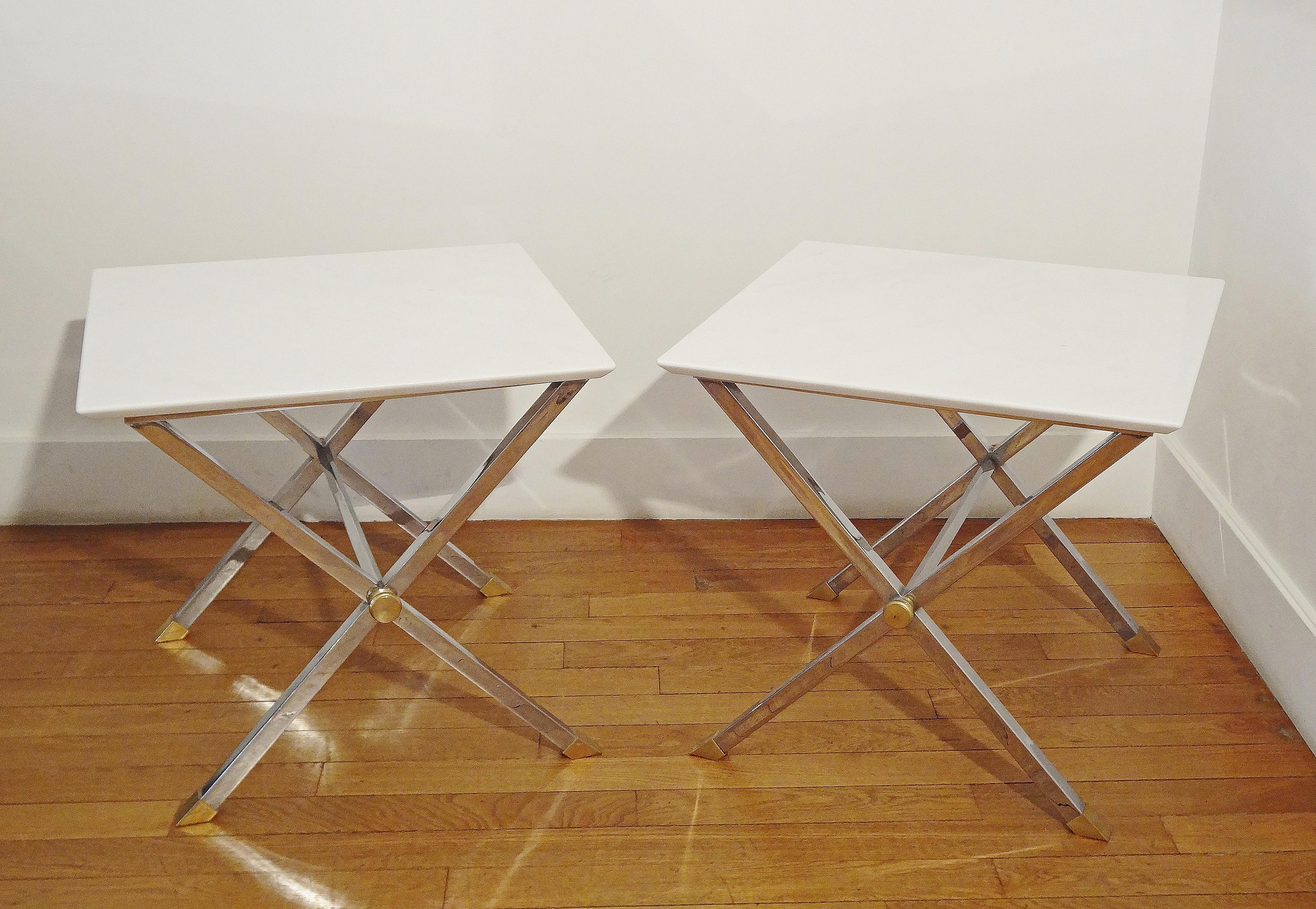 Pair of square coffee tables, Italy, 1970s.
X-shape chromed steel base and white bevelled marble top.
Gilt brass sabots and button.
Attributed to Alfredo Freda, Rome.
    
