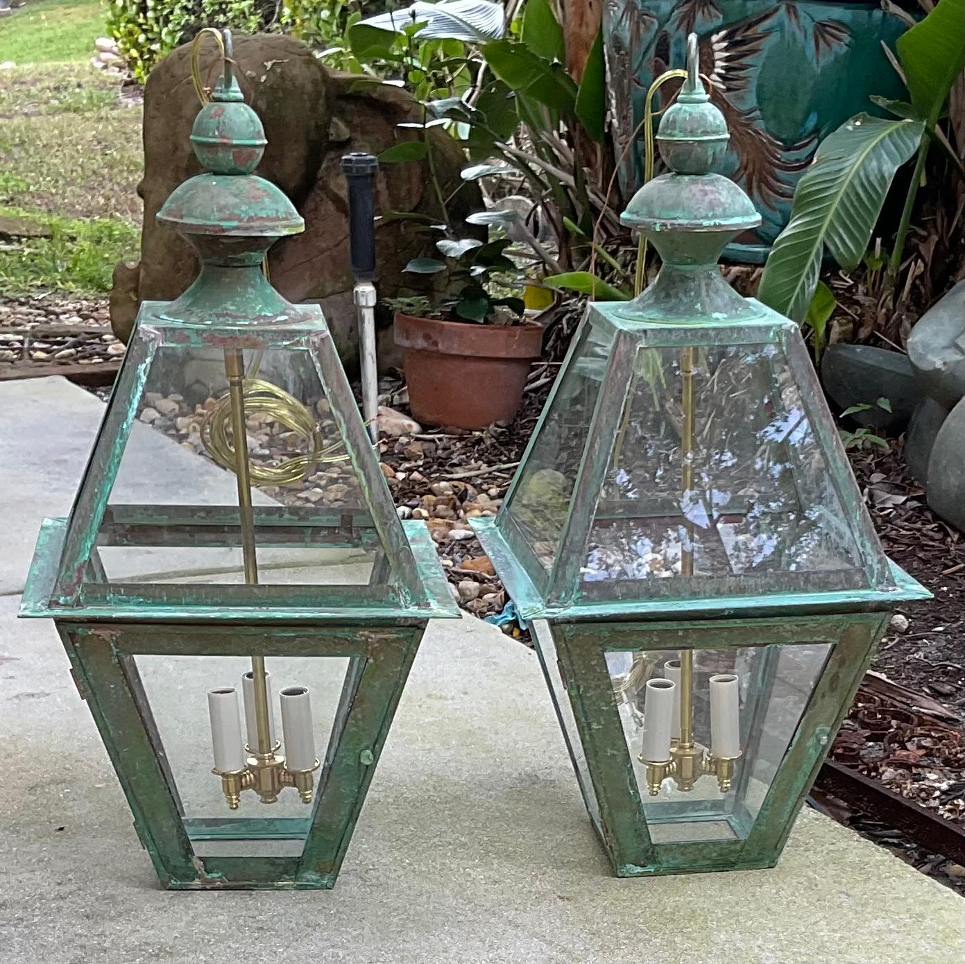 Exceptional four sides hanging pair of lanterns made of handcrafted solid copper and brass stem with three  60/watt lights, beautiful patina ,suitable for wet location ,Made in the US ,great look indoor or outdoor.  canopy and chain included.