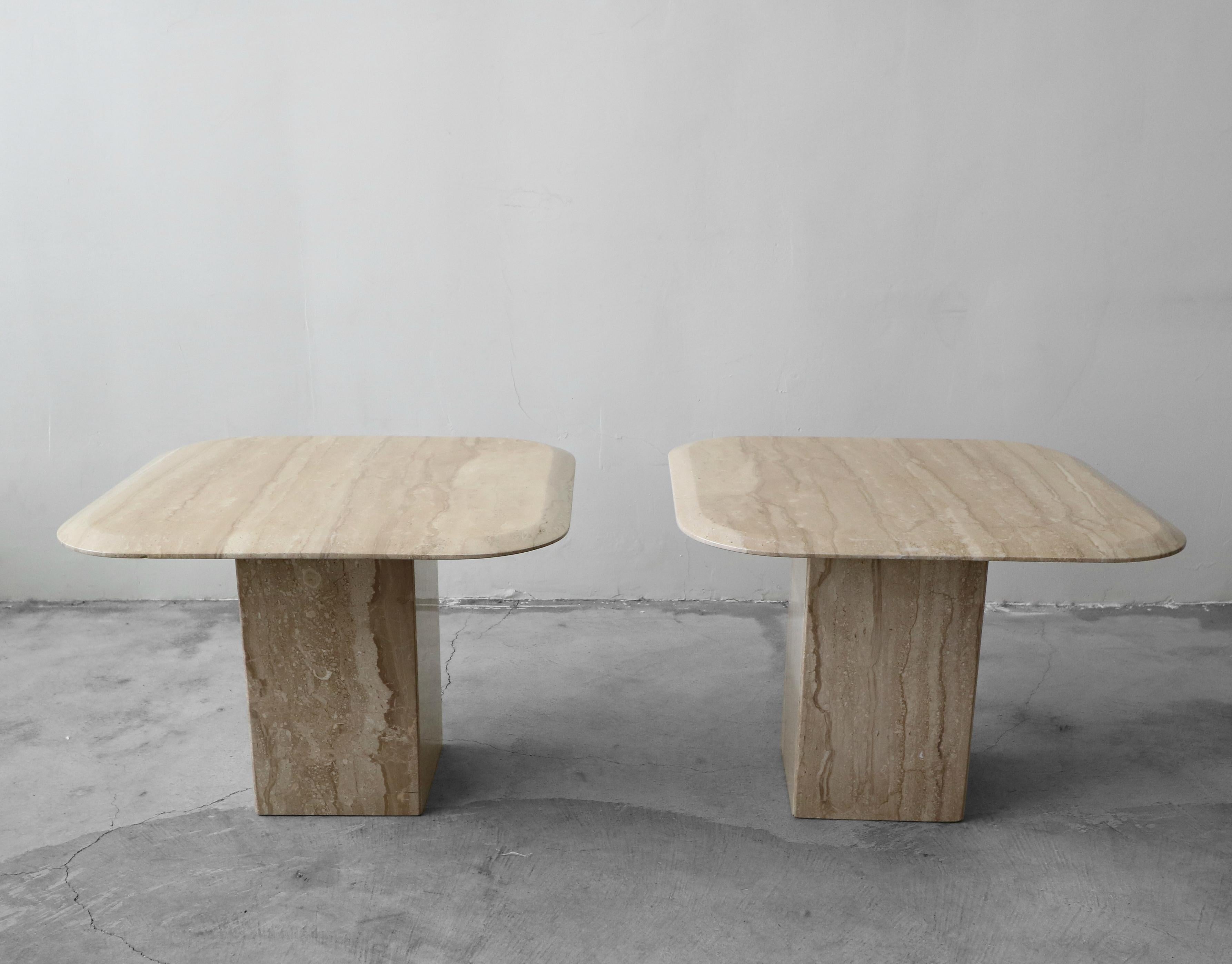 A beautiful pair of square Italian travertine side tables. Tables are polished and feature a clean beveled edge, seldom seen on travertine. Travertine is cream and beige in color with stunning natural details.

Tables are 2 separate pieces, a