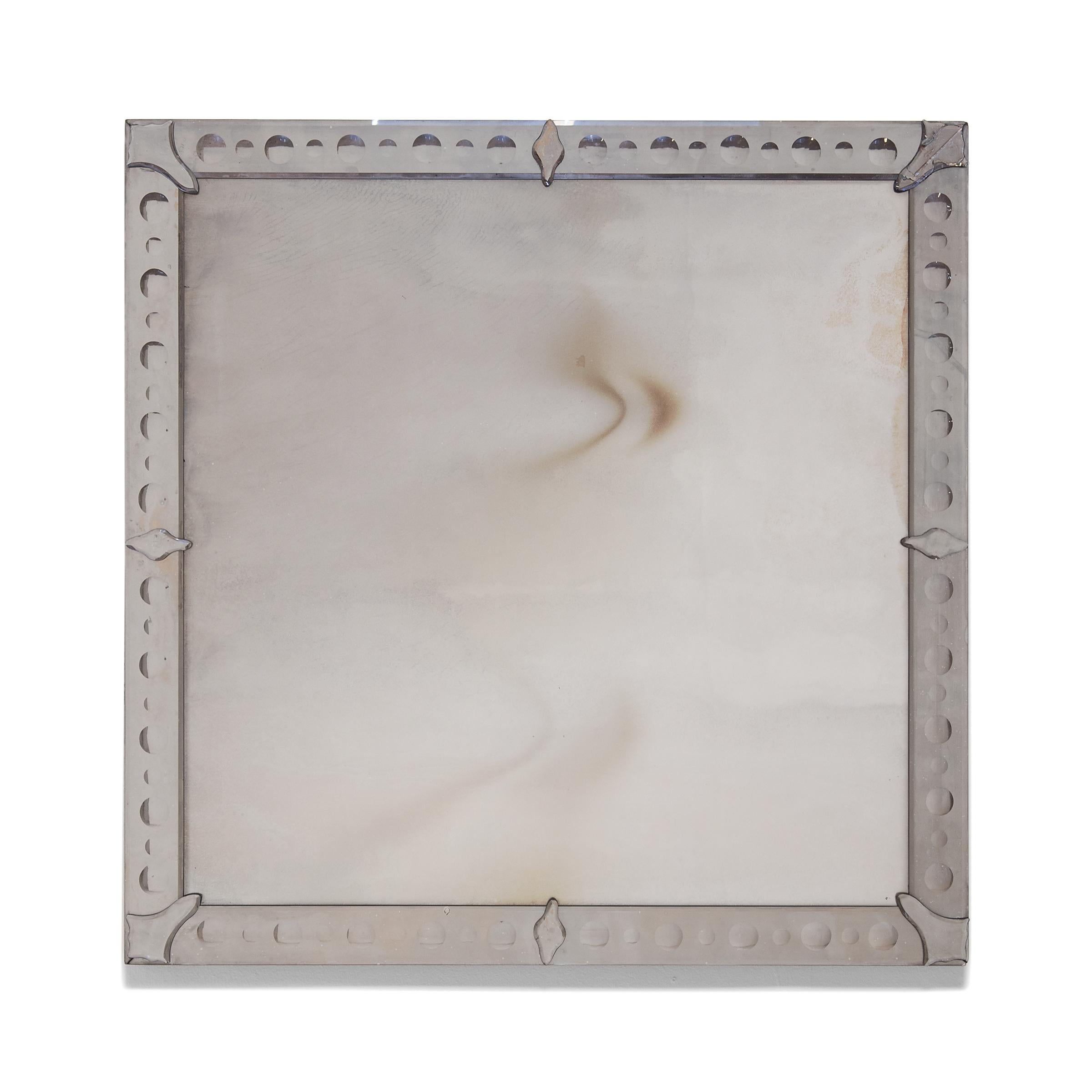 This pair of vintage wall mirrors is a nod to the imaginative designs of the global Art Deco movement of the early 20th century. The square mirrors are each set within mirrored frames decorated with a pattern of bubble-like convex circles. Affixed