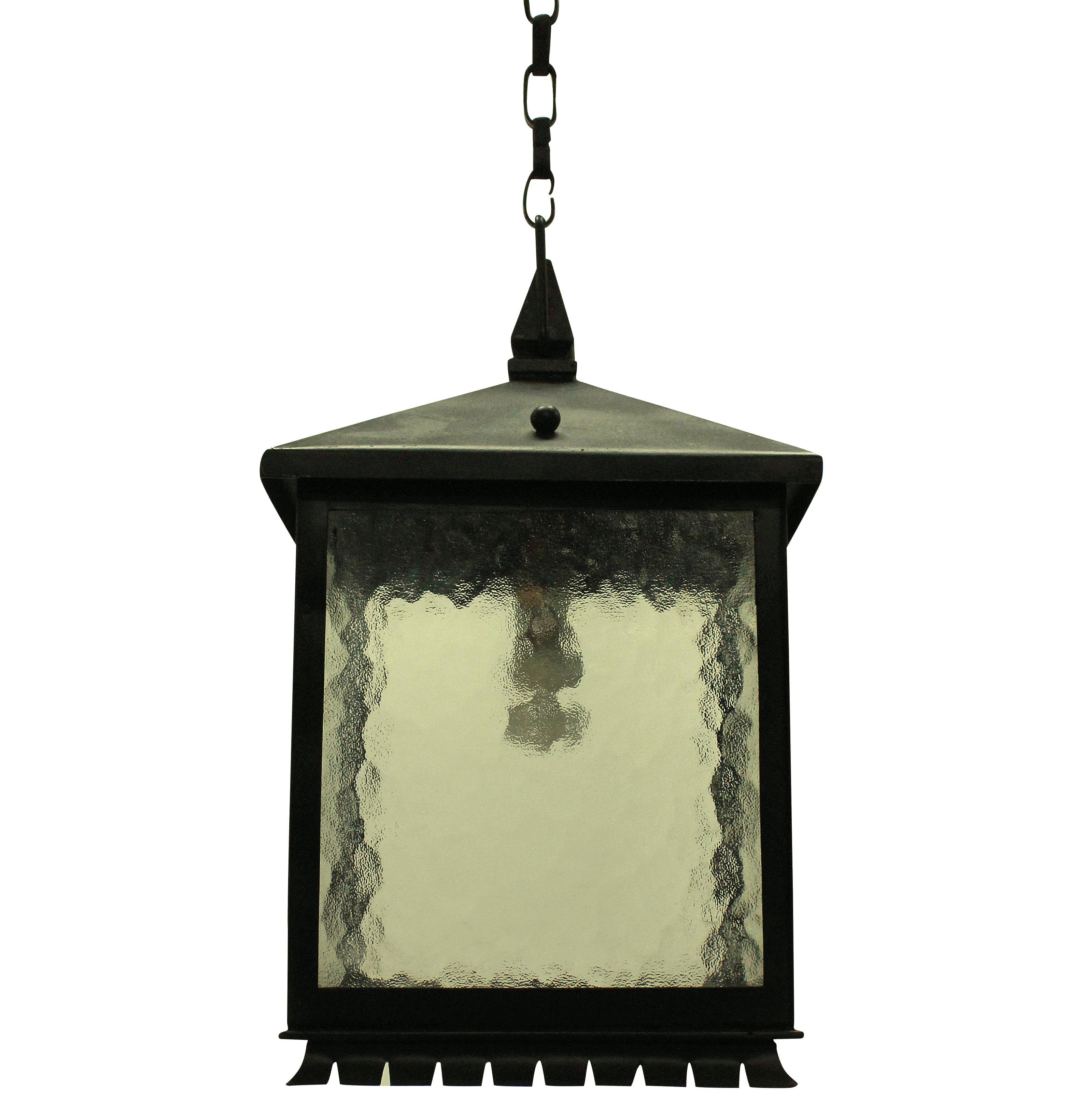 A pair of English wrought iron lanterns of square design with a pagoda roof and glass panels.