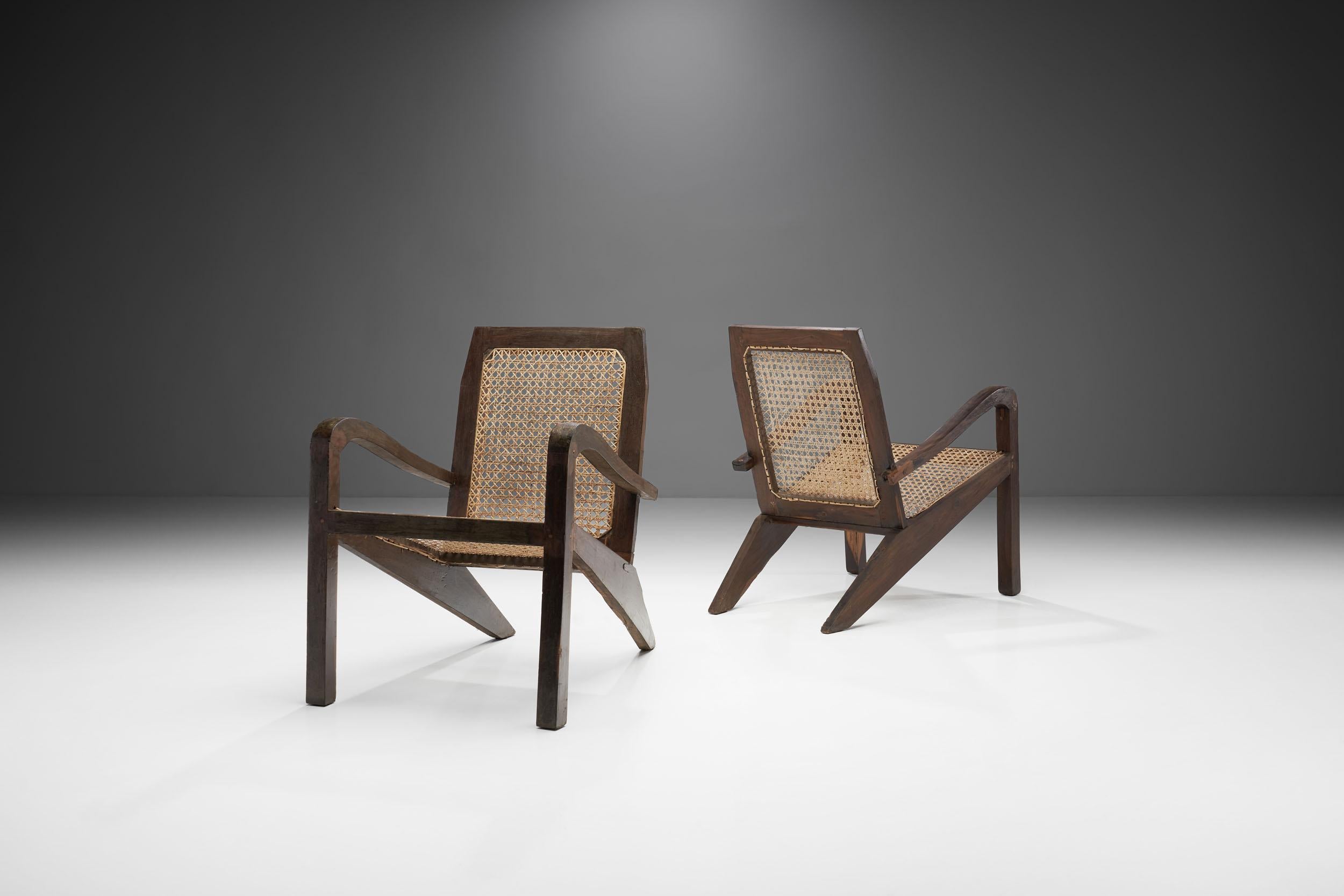 These rare Sri Lankan wood and cane chairs recall the midcentury style of Pierre Jeanneret, while being beautiful pieces on their own merit as well.

This pair is made of high-quality wood with the seat and back upholstered with cane. The organic