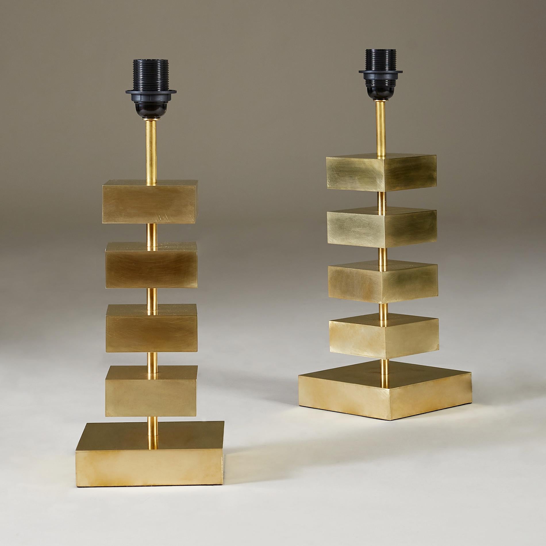 Bold 'Luigi' table lamps. Four impressive solid brass floating squares connected by slim brass columns. Larger brass square at the base. 

Also sold individually.

Measures: 47cm high (lamp only) x 16cm² wide (base).

62cm high x 36cm diameter
