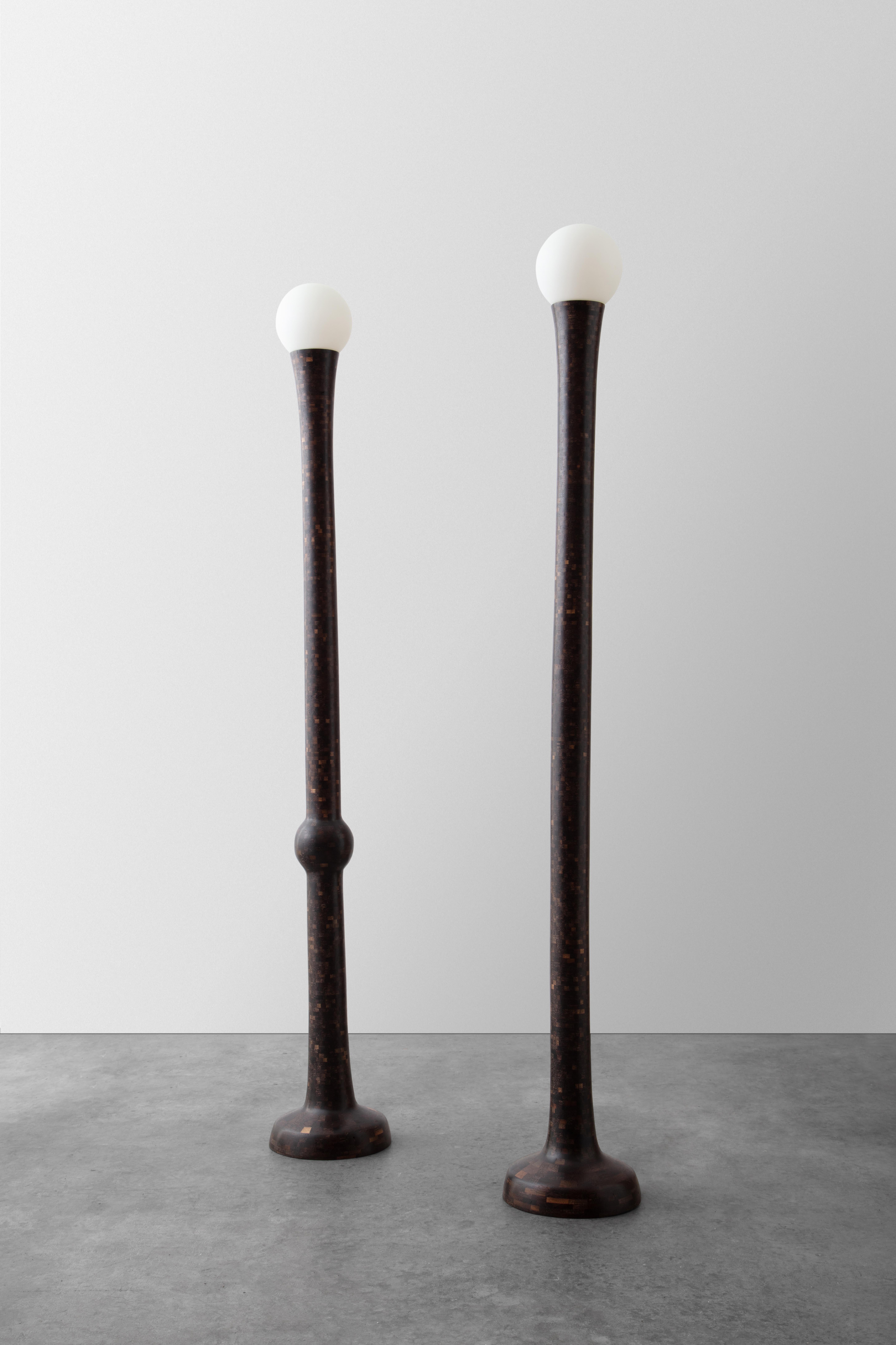 .This pair of STACKED post floor lamps was created from thousands of tiny pieces of wood, approximately 5000 pieces in each one. The simple column forms are subtly irregular and possess a slightly playful nature, perfectly imperfect. 

Made from