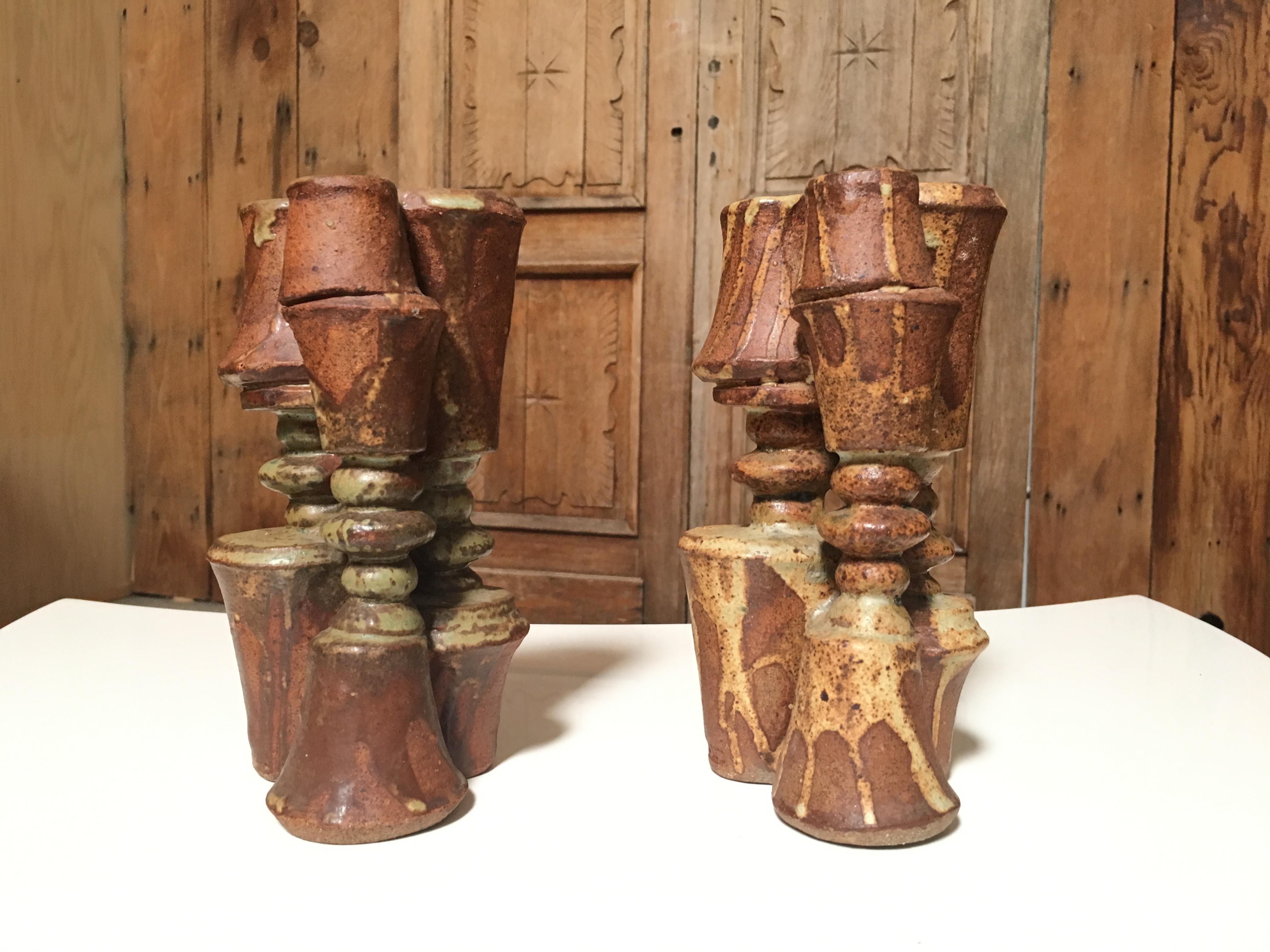 Pair of brutal ceramic candle sticks.

In 1960 he set up his own workshop in Forest Hill, London, Progressive designs were readily accepted in London at that time, and Rooke applied his efforts to making pieces of a sculptural nature. The early