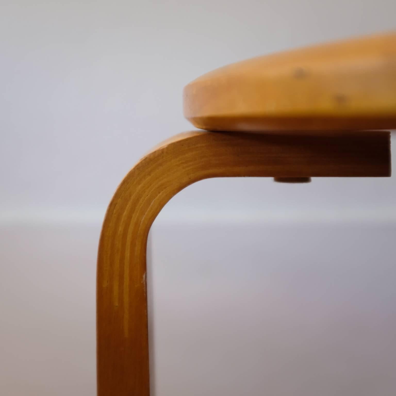 A pair of birch stacking stools. Curved edge seat. The leg bends have the fingered joinery identical to Alvar Aalto. Stamped, 