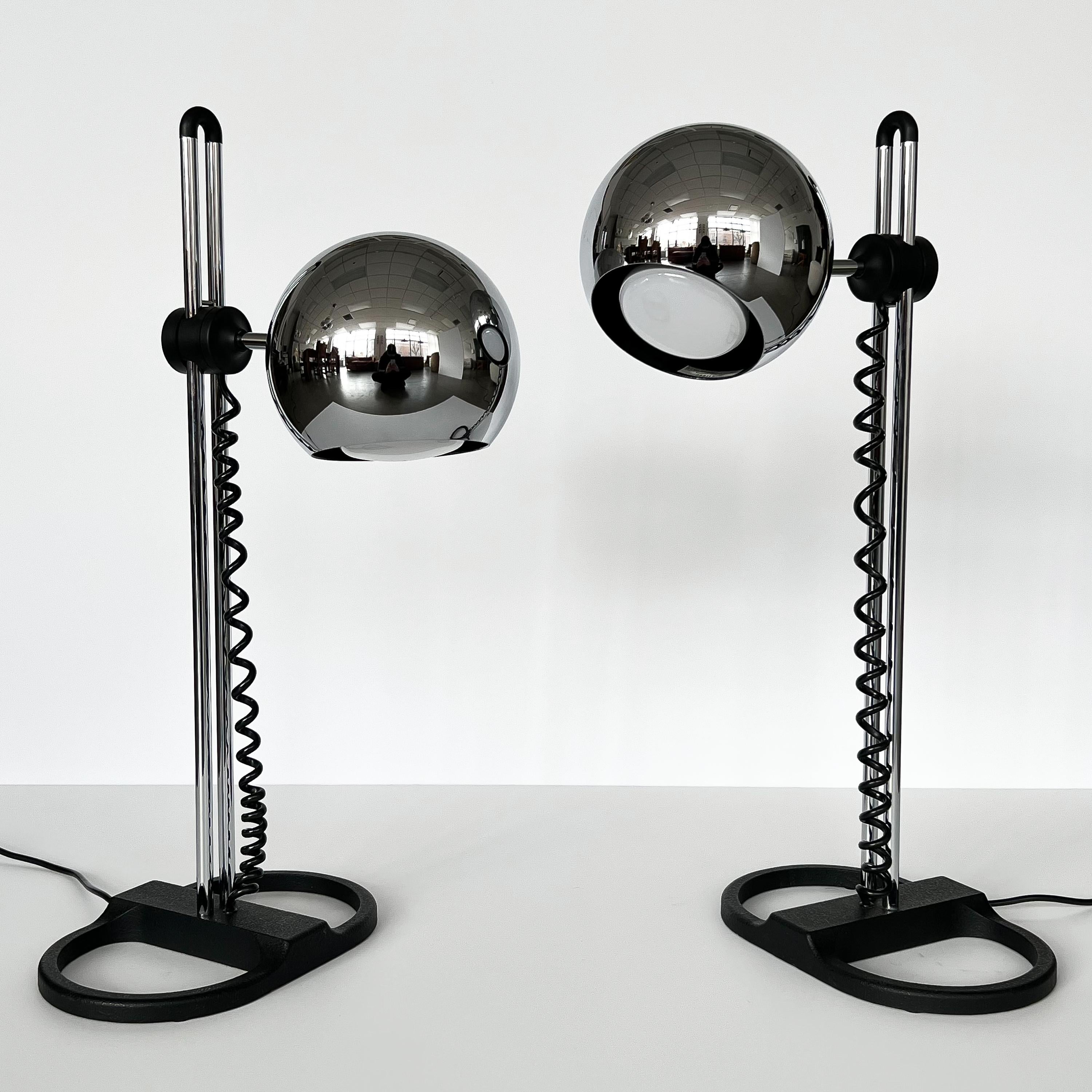 Pair of Staff Leuchten chrome adjustable eyeball table lamps, Germany circa 1970s. These lamps feature 7