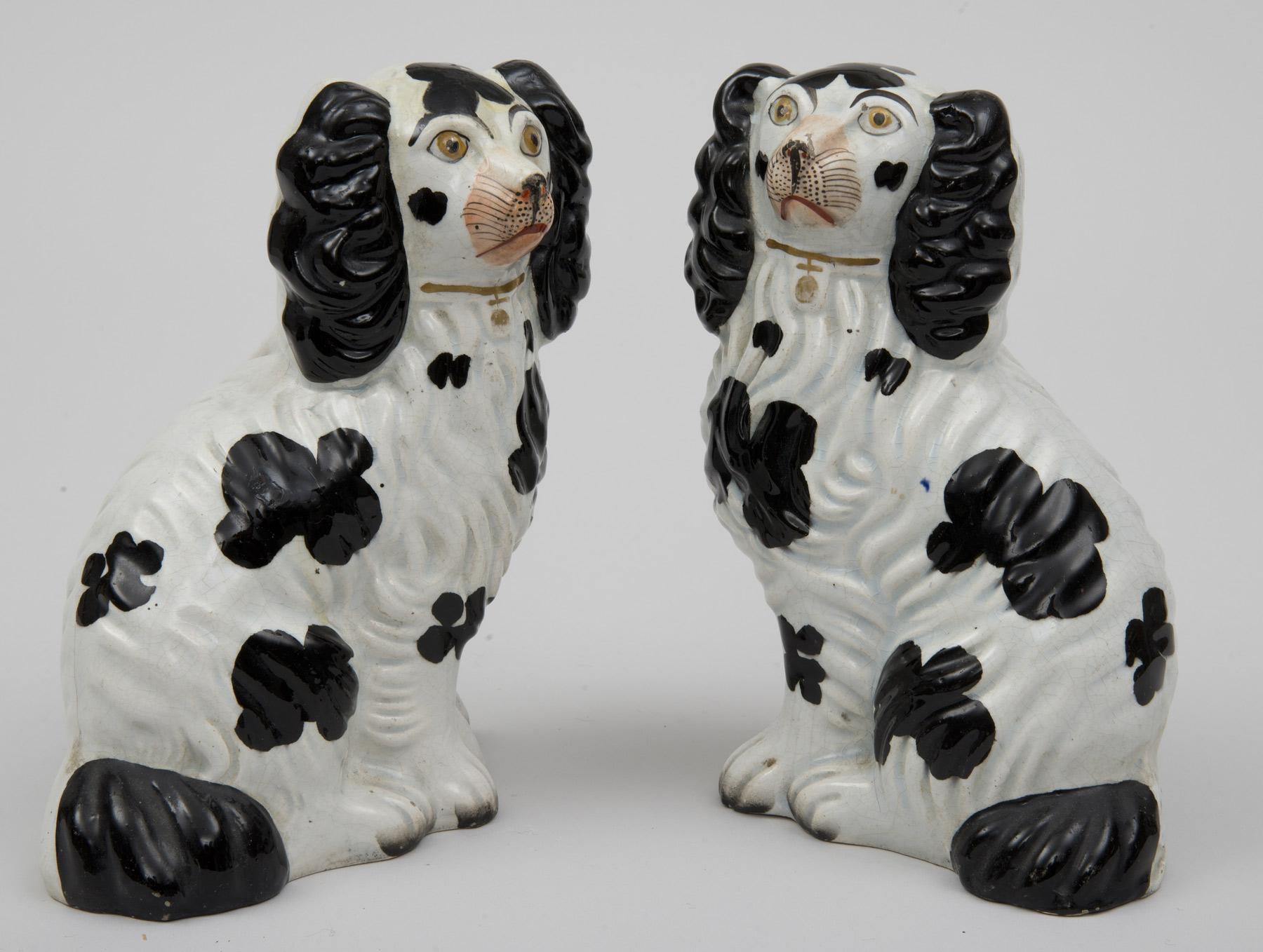 Pair of black and white no. 5 Staffordshire Spaniels wearing gilded collars, circa 1850.