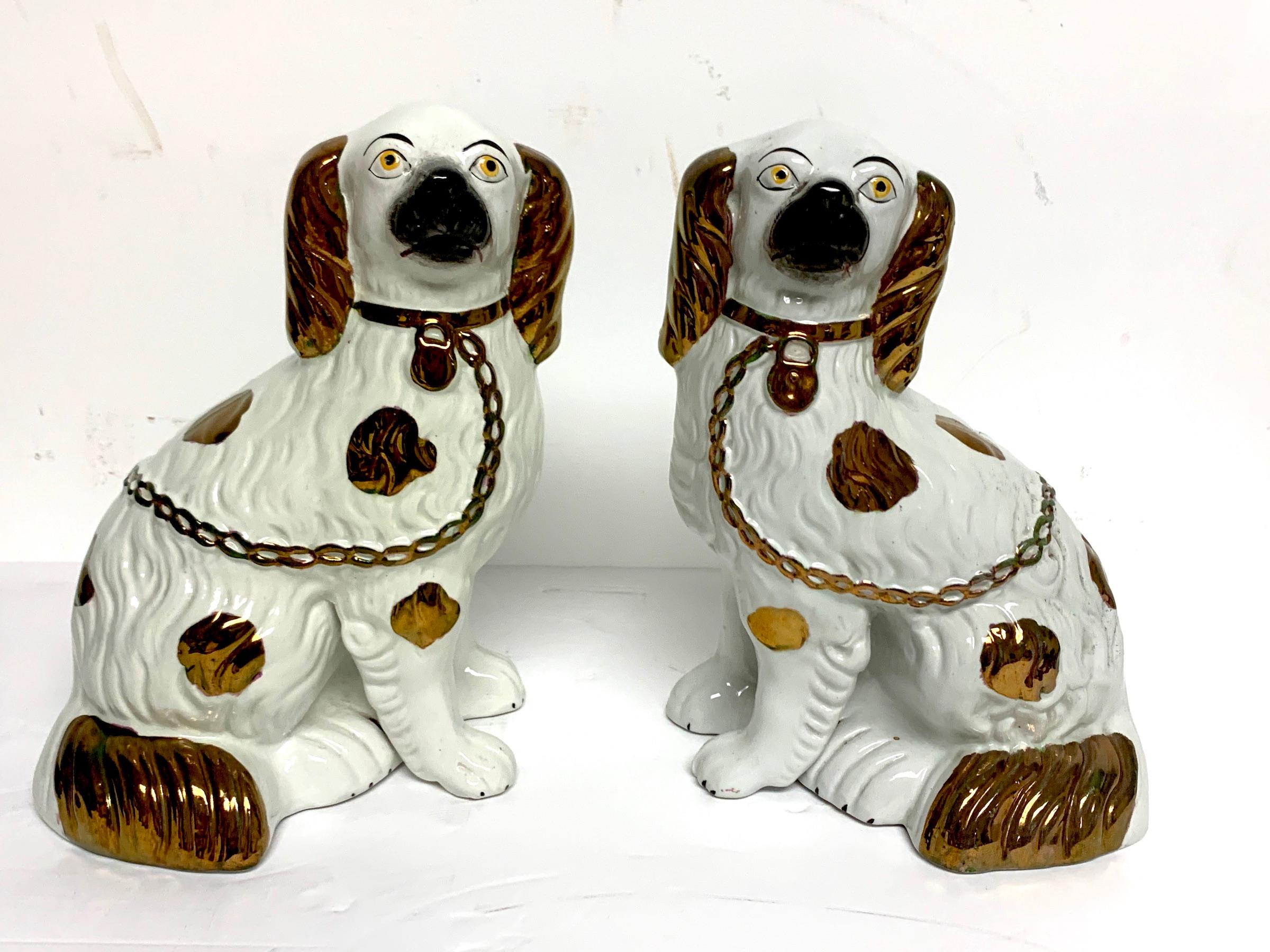 Pair of Staffordshire copper luster dogs with separated legs, taller.
  