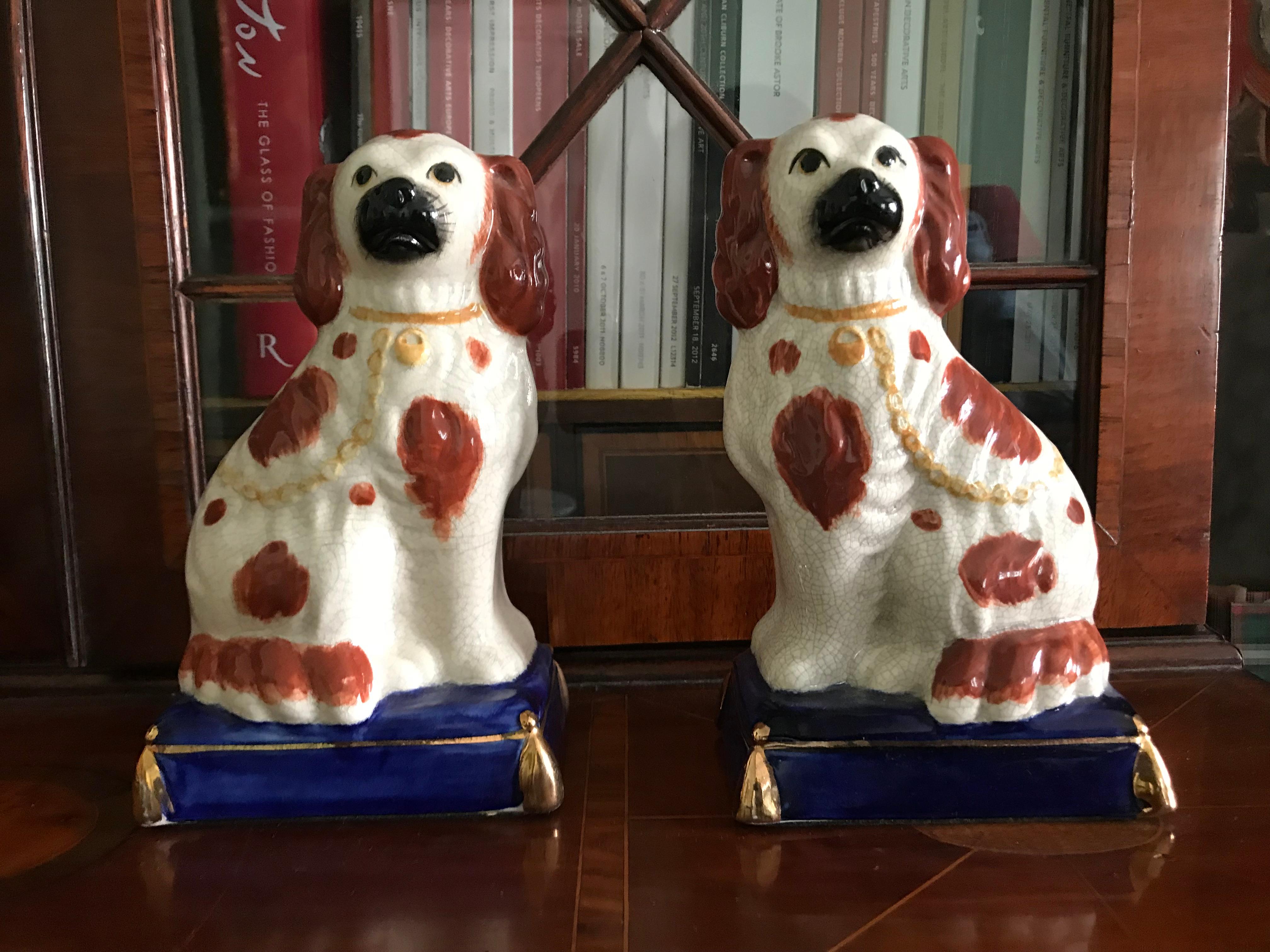 Lovely pair of Staffordshire dogs; a very decorative pair, supported on a bright blue base with gilded details, late 19th-early 20th century.

Wear consistent with age and use.



 