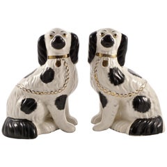 Antique Pair of Staffordshire Hand Painted Black and White Pottery Dog Figurines