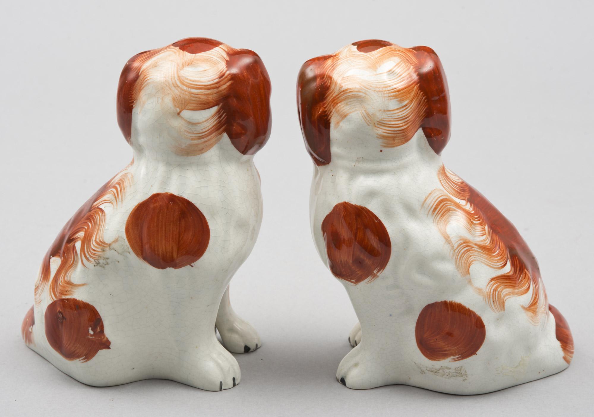 Pair of red Staffordshire King Charles spaniels with separate front legs.
