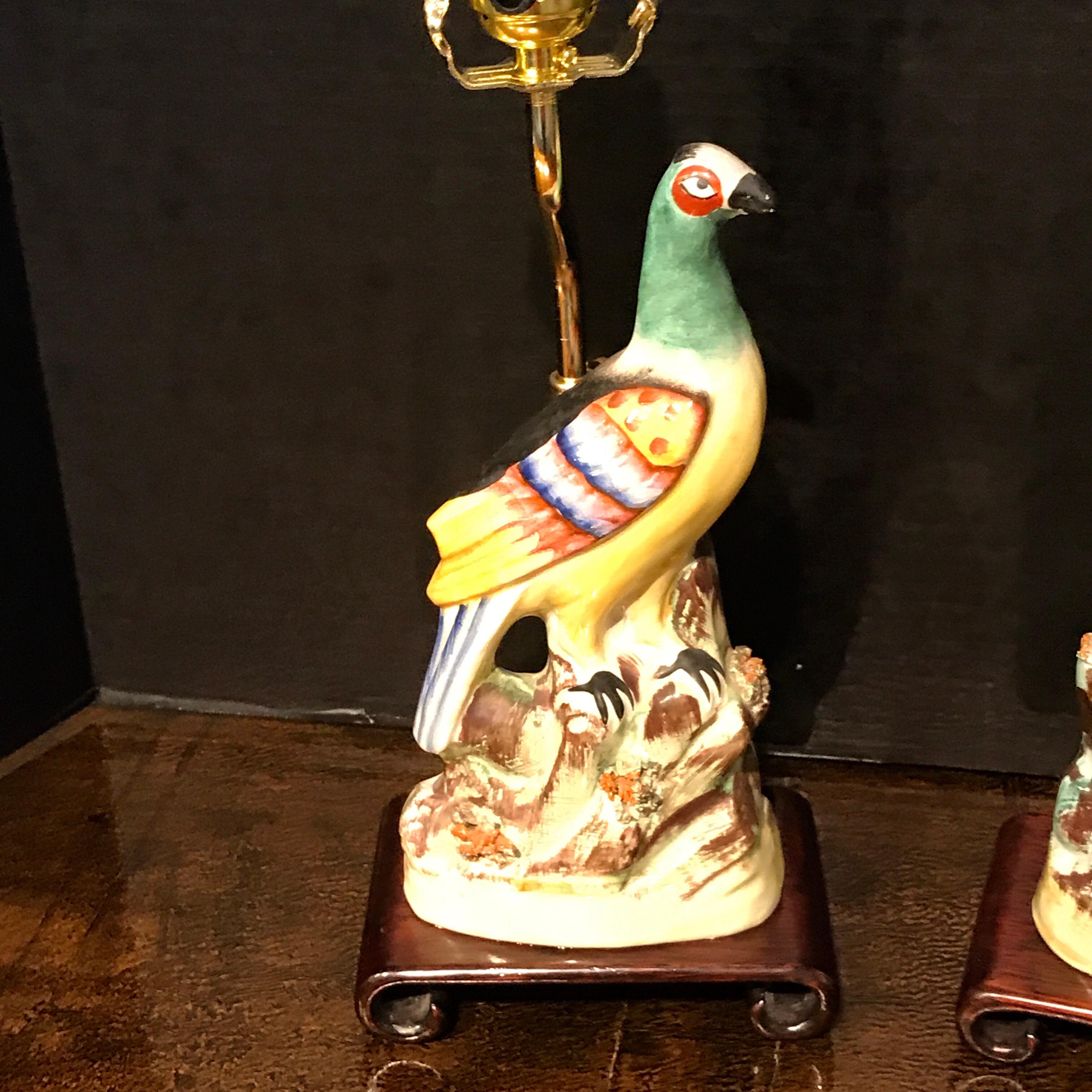 Pair of Staffordshire Quail figures, now as lamps, each one mounted on scroll foot hardwood stand with brass fittings. The height of the figures 12