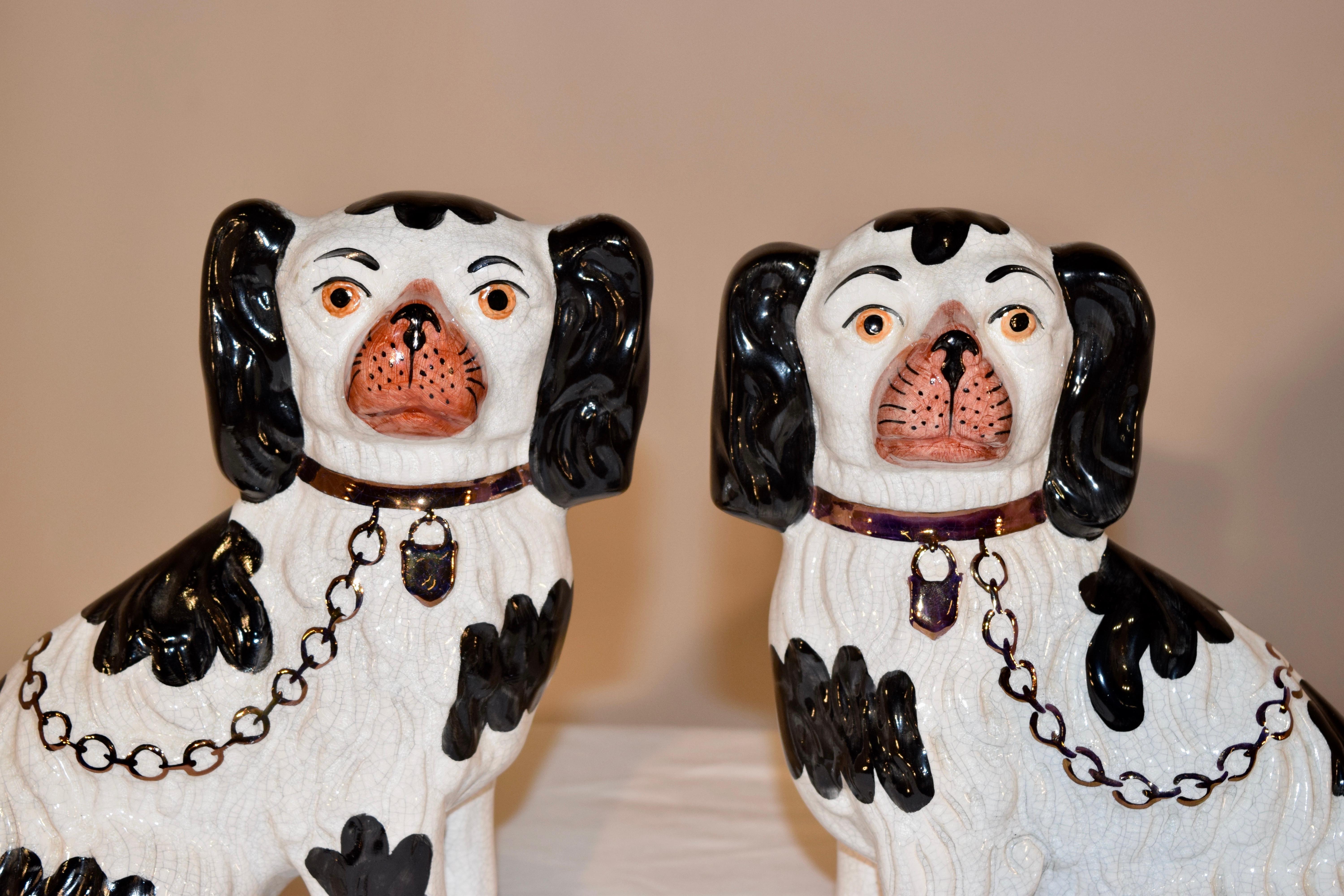 Pair of mid-20th century Staffordshire spaniels, made by and marked William Kent Ltd. The mark was used between 1944-1962. This is a wonderful pair of black and white spaniels with separated front legs. Great condition.