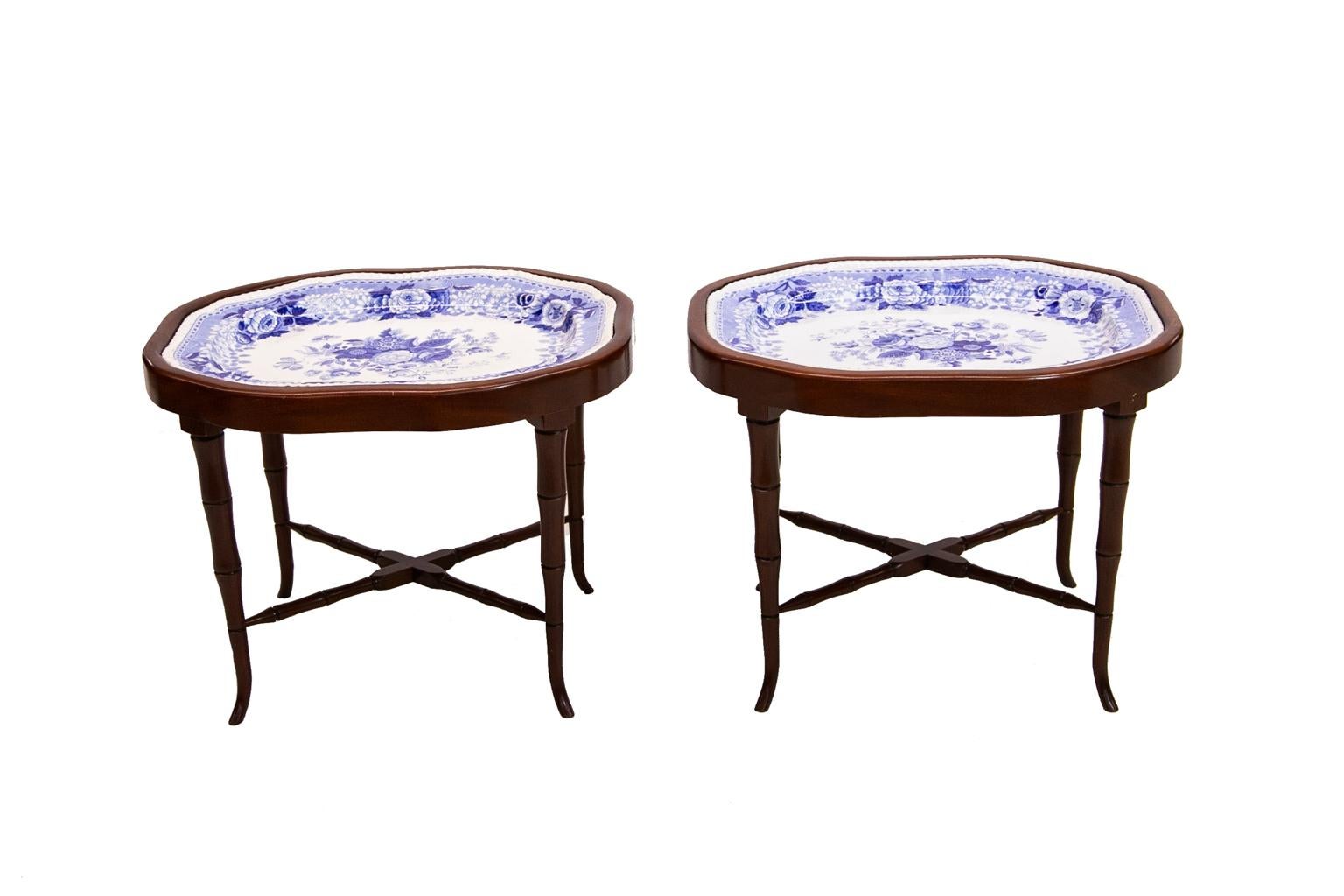 Pair of Staffordshire tray tables were made from two large Staffordshire platters. The stands were custom built to fit the platters. The stands have faux bamboo turned legs and cross stretchers. One platter is signed 