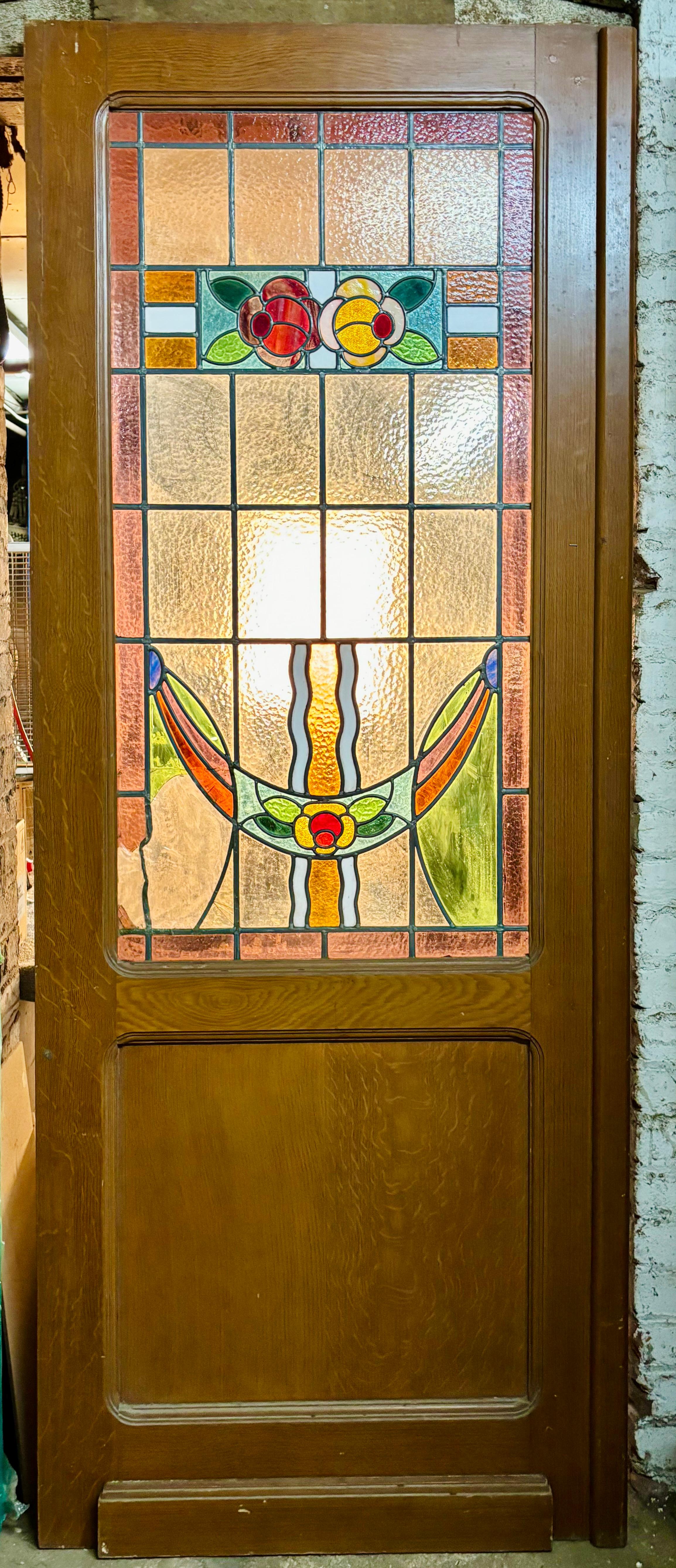 This pair of antique American doors feature beautiful stained glass windows with leaded designs. These will give great light into your room, while offering privacy. Each door is 30