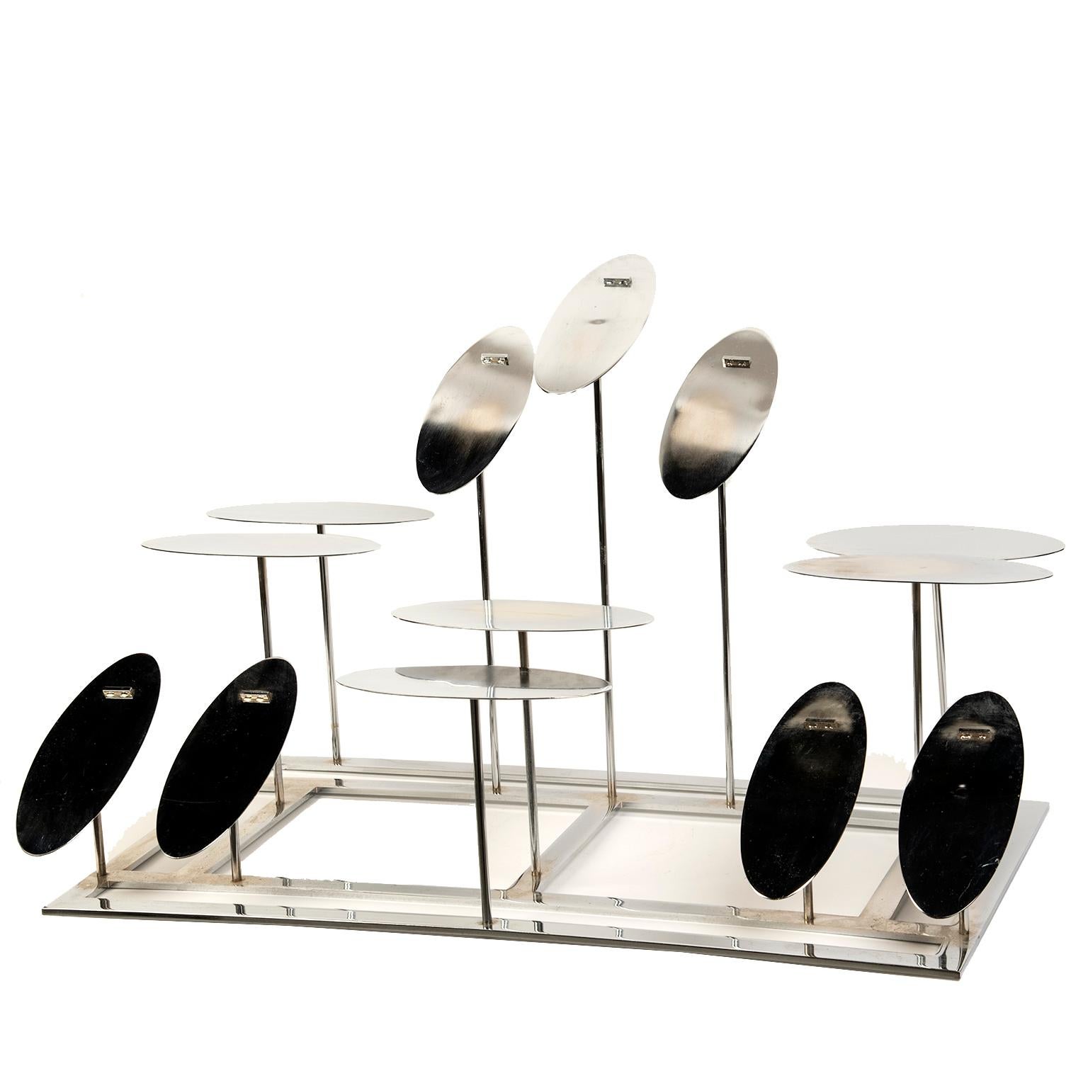 These unique and chic vintage stainless steel shoe displays are perfect for home to feature and organize 
your favorite shoes. They were designed for a high end shoe retailer in the 1980’s and are almost
sculptural in appearance with their varying