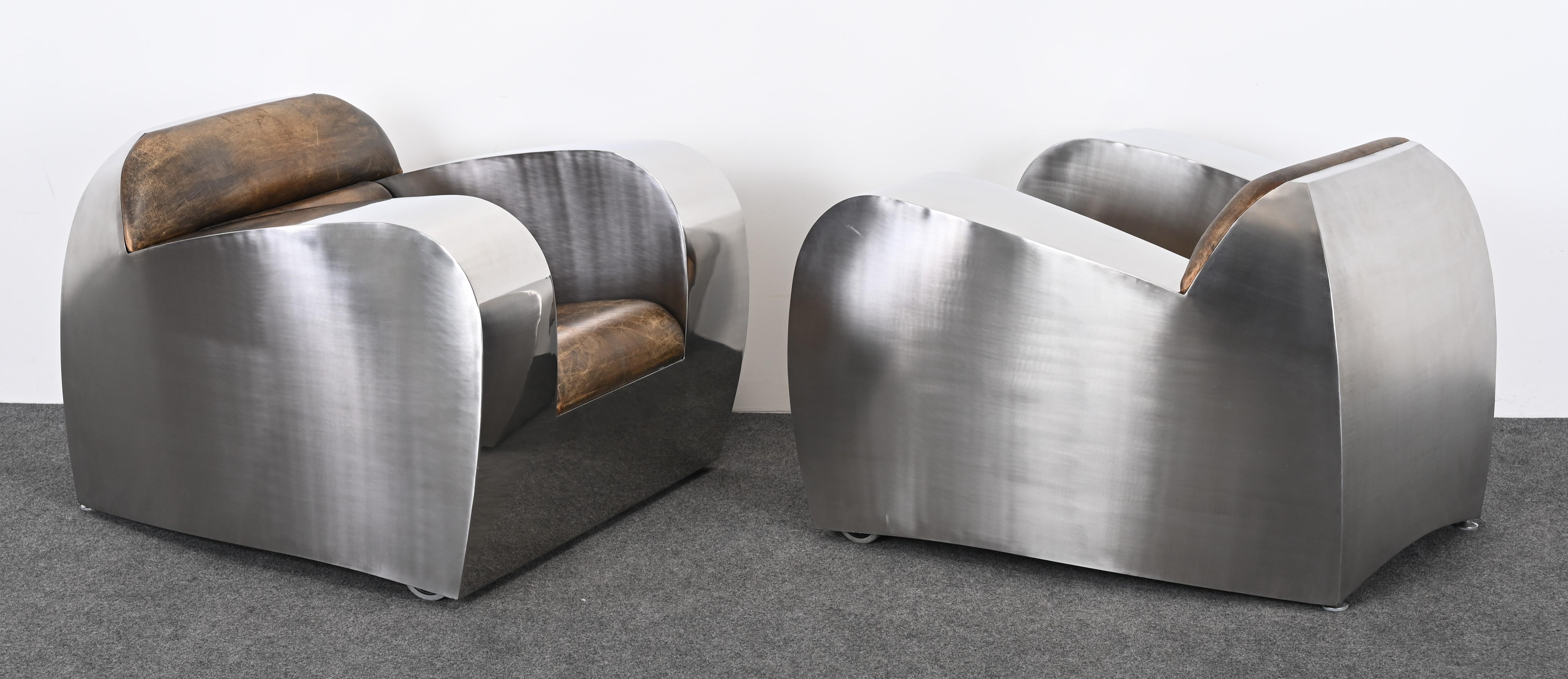 A magnificent stainless steel and leather club chairs or armchairs by Jonathan Singleton, 1980s-1990s. This fabulous pair of chairs fall into the art furniture category. Designed by metal artist and sculptor Jonathan Singleton and created in his
