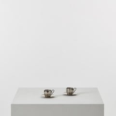 Pair of stainless steel espresso cups and saucers - UK, 20th century