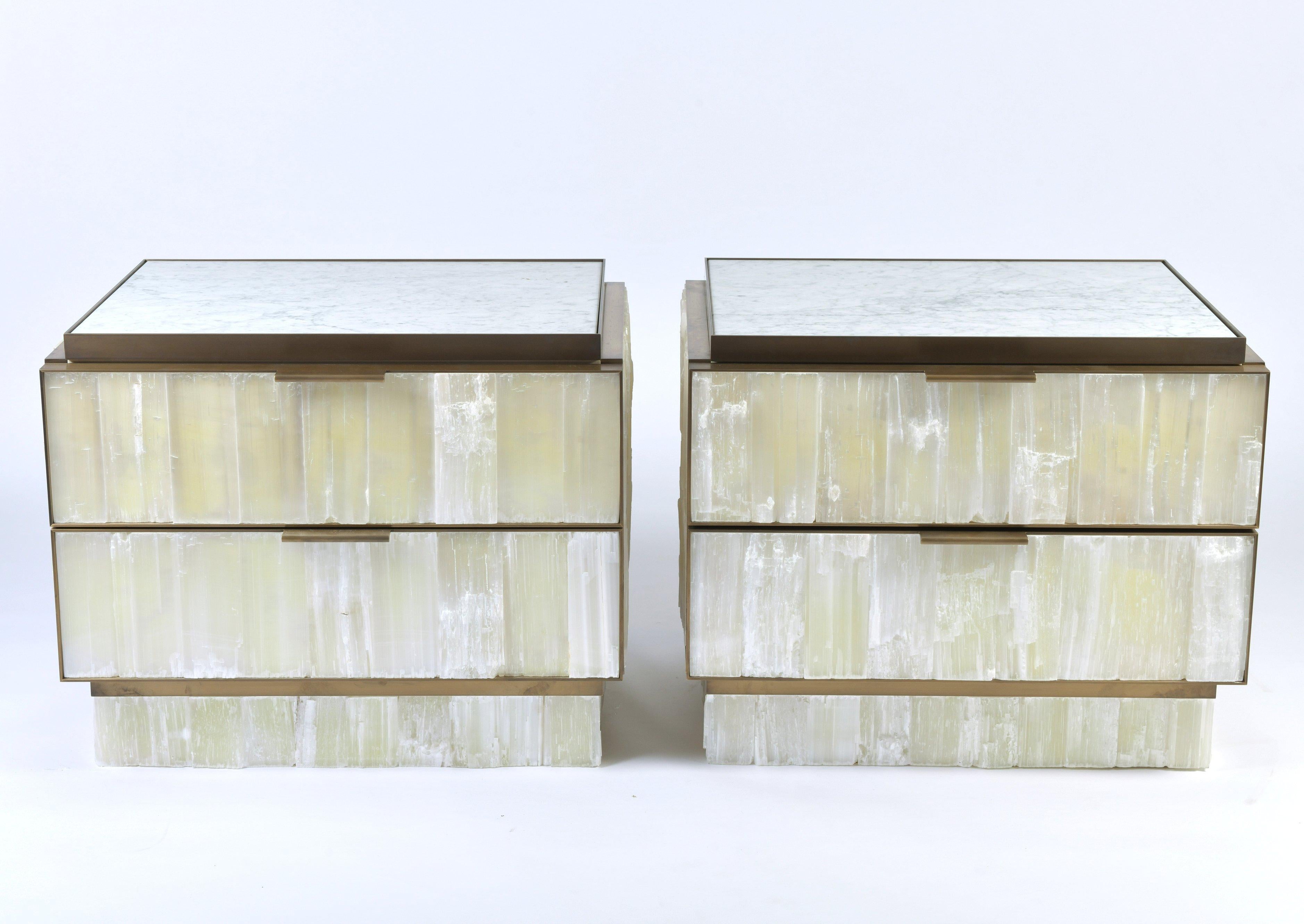 These stunning and top quality stalactite crystal bedside cabinets features 2 drawers supported on a plinth base with bronze metalwork. The dark veined white marble top is interchangeable if required. Each cabinet measures 26 in – 66 cm wide, 19 in