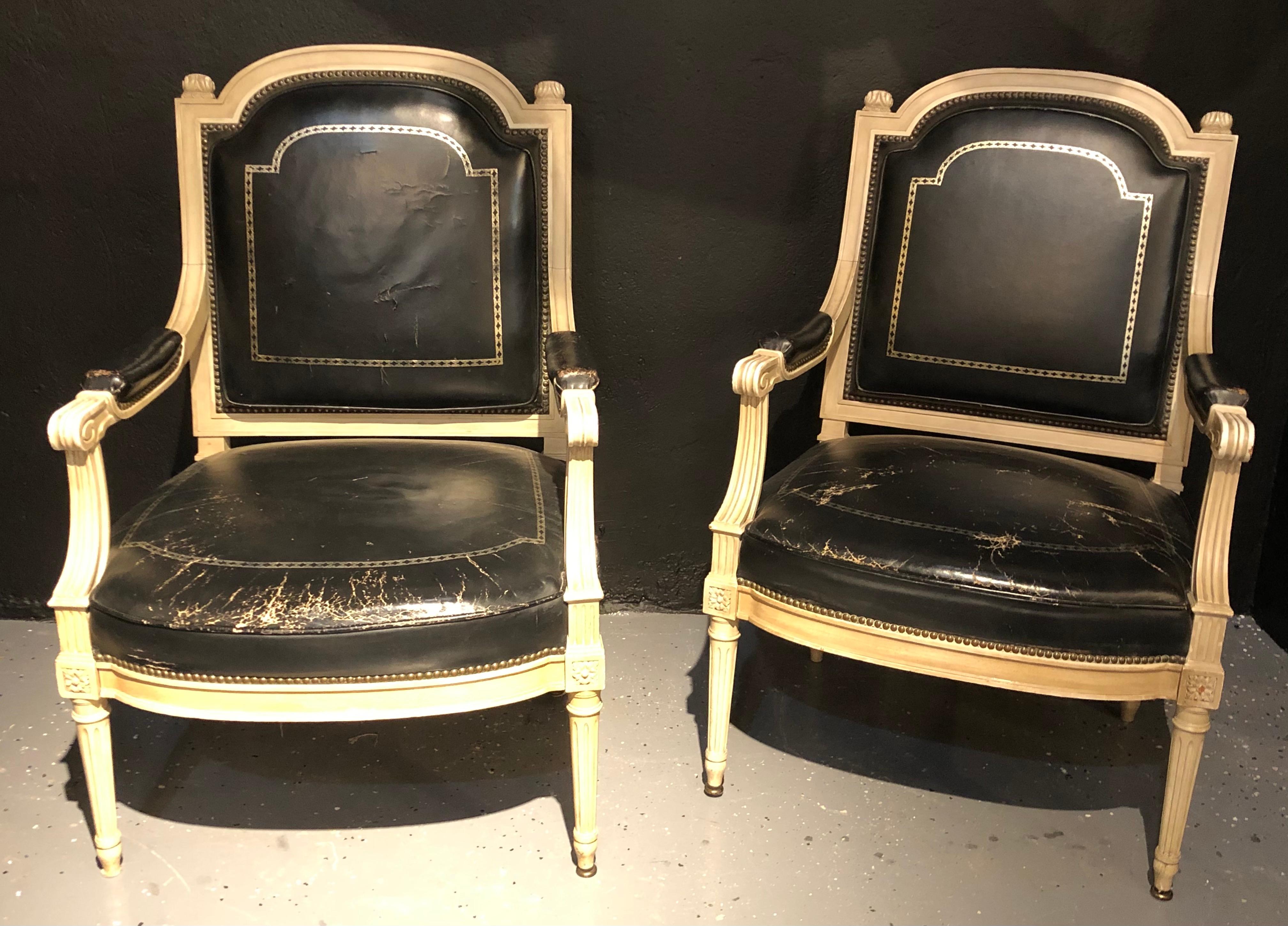Pair of stamped Jansen bergères/ armchairs black in a tooled leather upholstery. This simply stunning example of this highly sought after designers work depicts the Hollywood Regency era at its peak. The clean sleek and stylish form in a Louis XVI