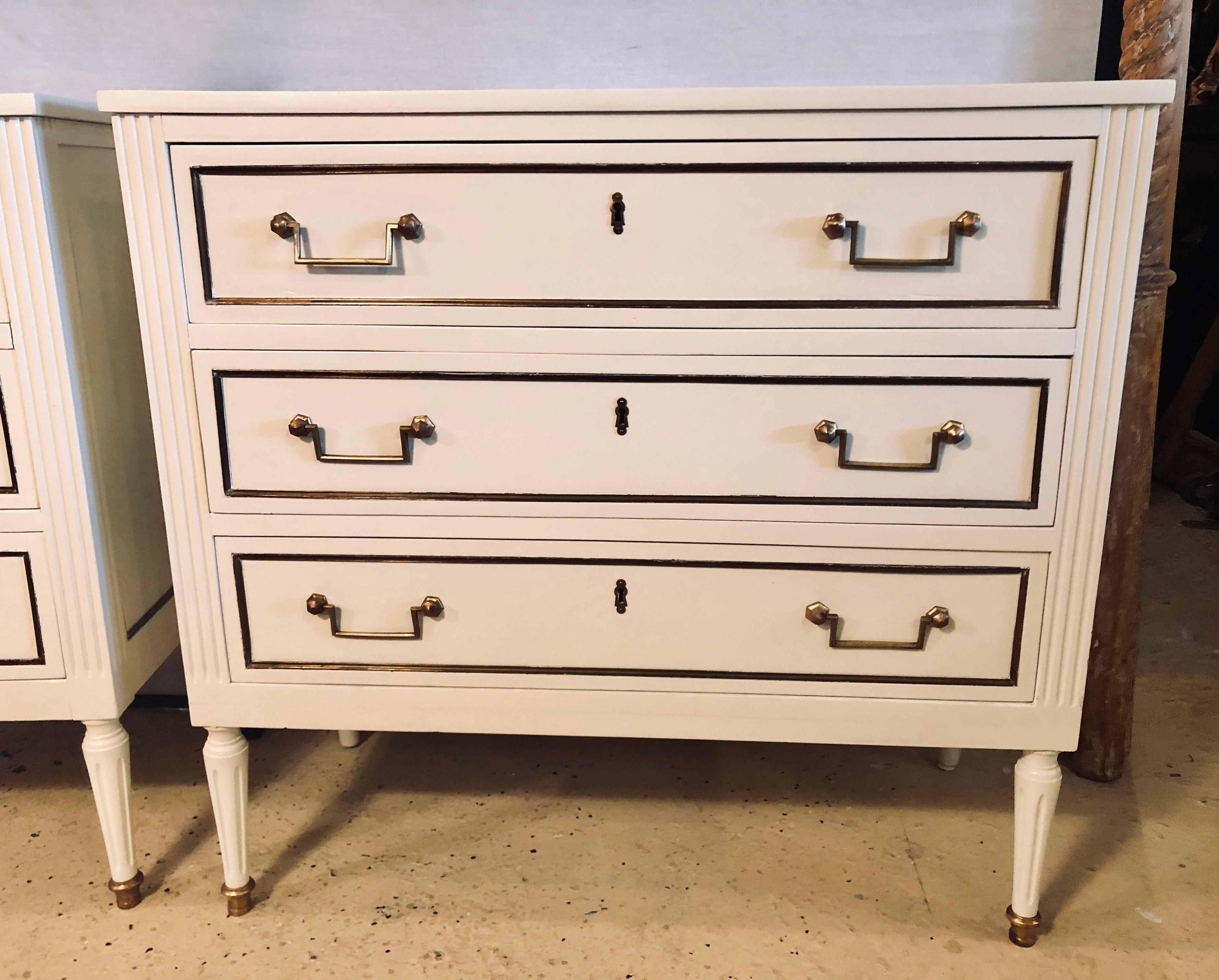 Pair of stamped Jansen commodes or nightstands chests in Louis XVI style. Versatility is the key in this stunning recently refinished pair of nightstands or commodes in the Hollywood Regency fashion. The pair bearing the JANSEN stamp in a fine linen