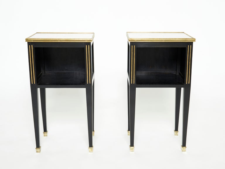 This rare pair of nightstands or end tables by French house Maison Jansen was created in the early 1950s with black varnished mahogany wood, with brass details and white marble top. Typical and timeless french neoclassical style from Maison Jansen,