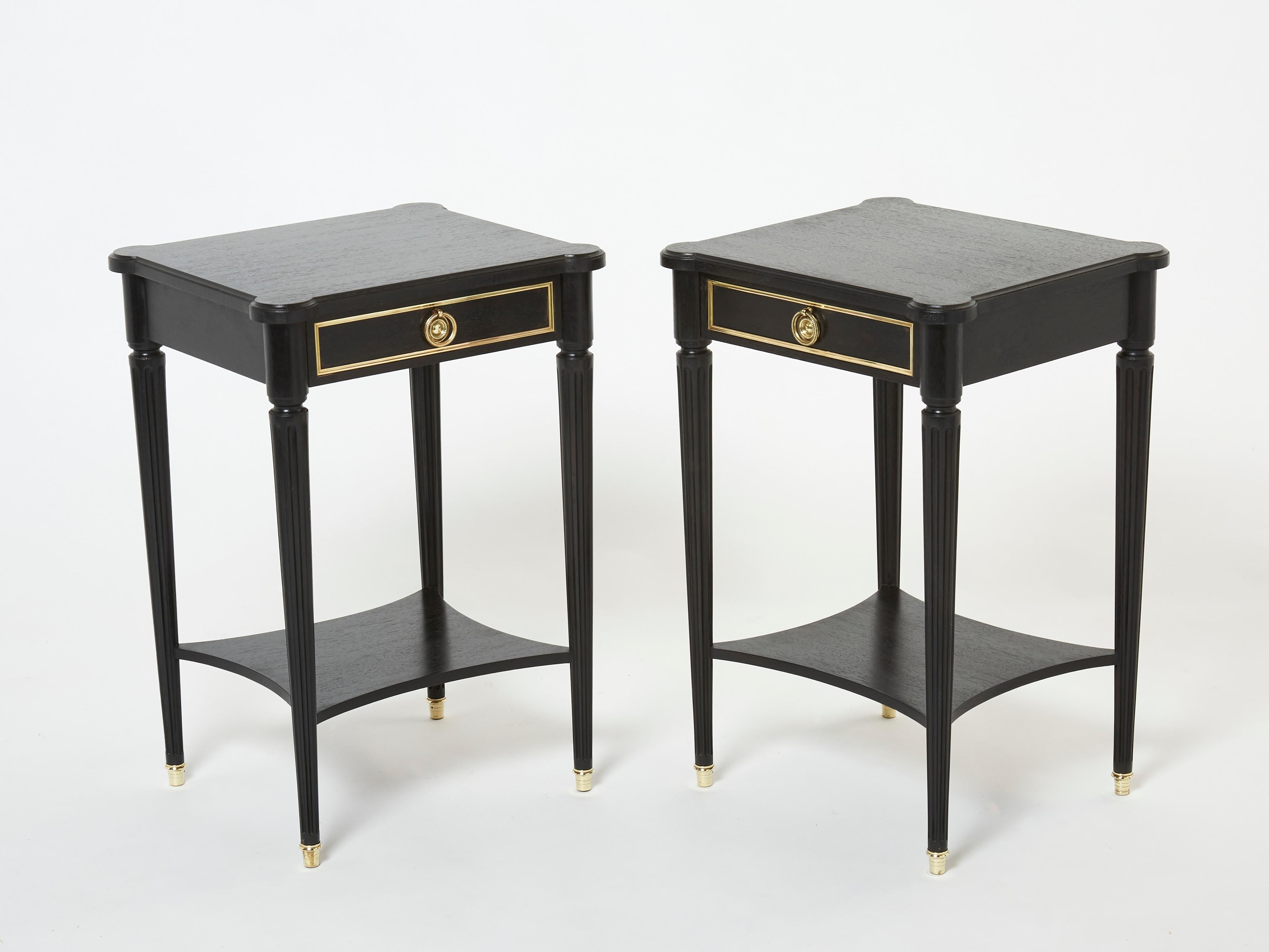 This rare pair of nightstands or end tables by French house Maurice Hirsch was created in the early 1960s with black varnished mahogany wood, with brass details, sabots and handles. Typical and timeless french neoclassical style from M. Hirsch, each