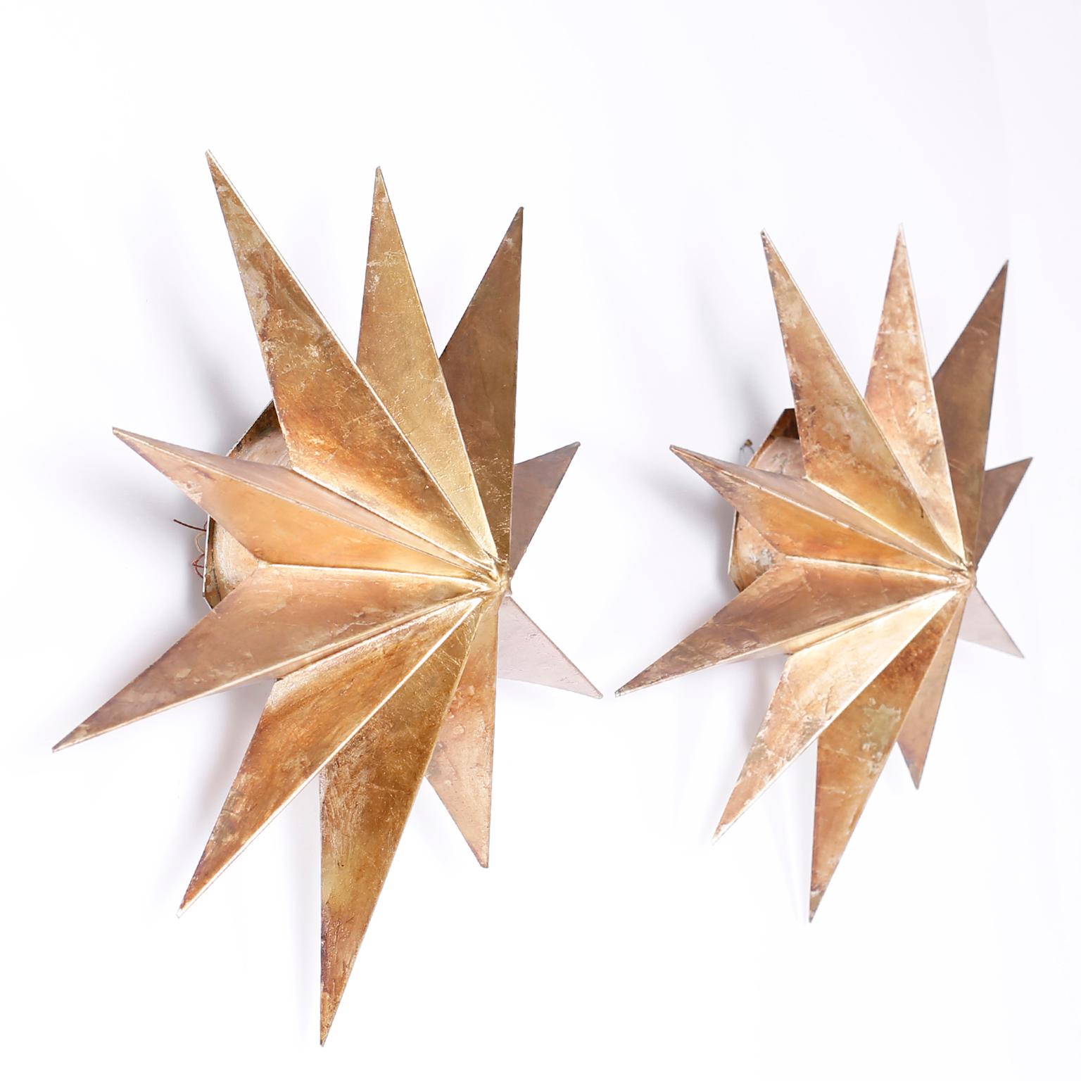 Pair of midcentury star form wall sconces with ten points, each crafted in aluminum with a gold leaf finish and spray lighting from behind. Newly wired.
