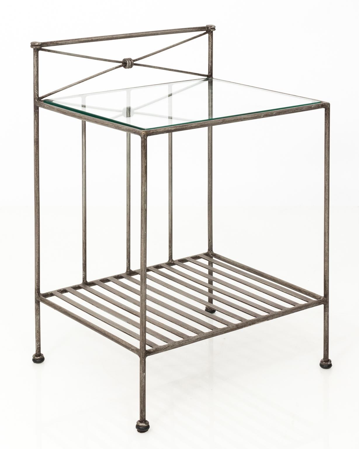 Pair of industrial two-tier steel end tables with glass top, circa 1970s.
 