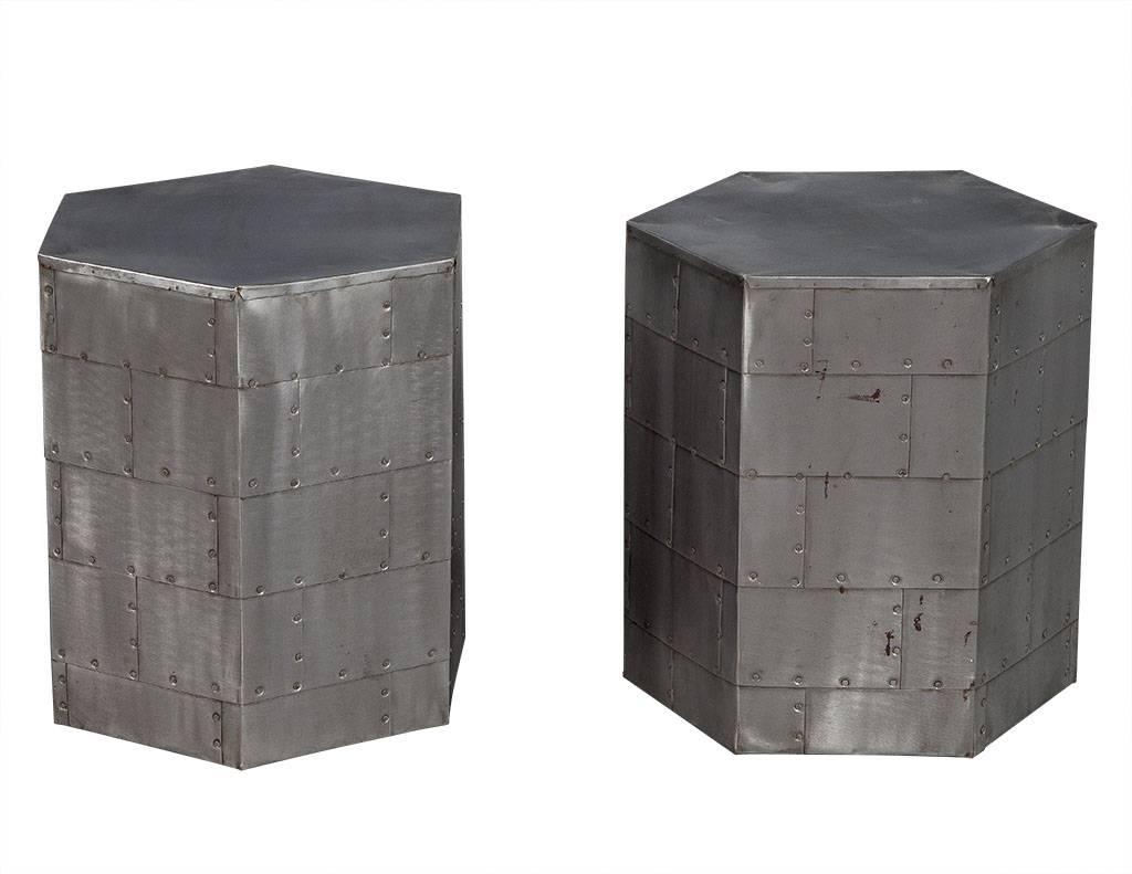 These industrial end tables are beyond unique. Each is composed of metal sheeting on the sides and tops with decorative rivets and signs of wear to add even more character. This pair is perfect for a one of a kind home!